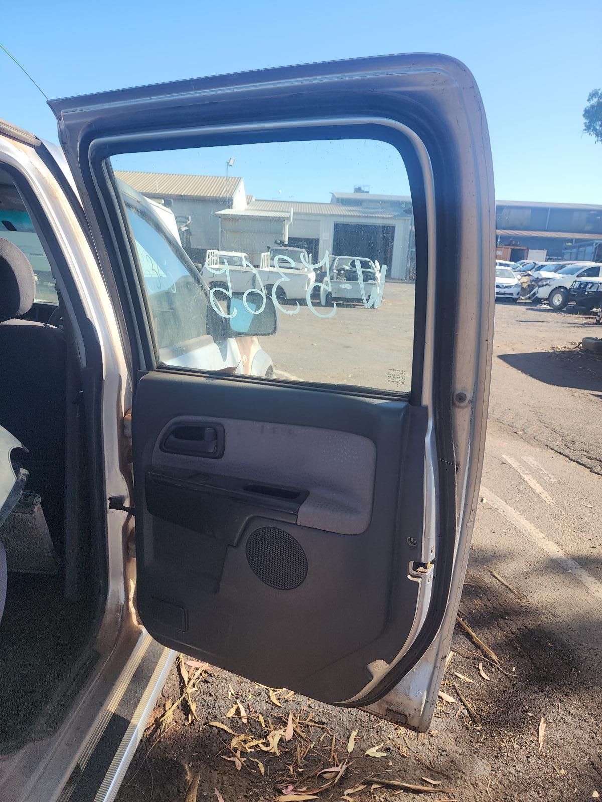 Open Car Door with Speaker, Overlooking an Outdoor Parking Lot on A Sunny Day — South West 4WD Wreckers In Harristown, QLD