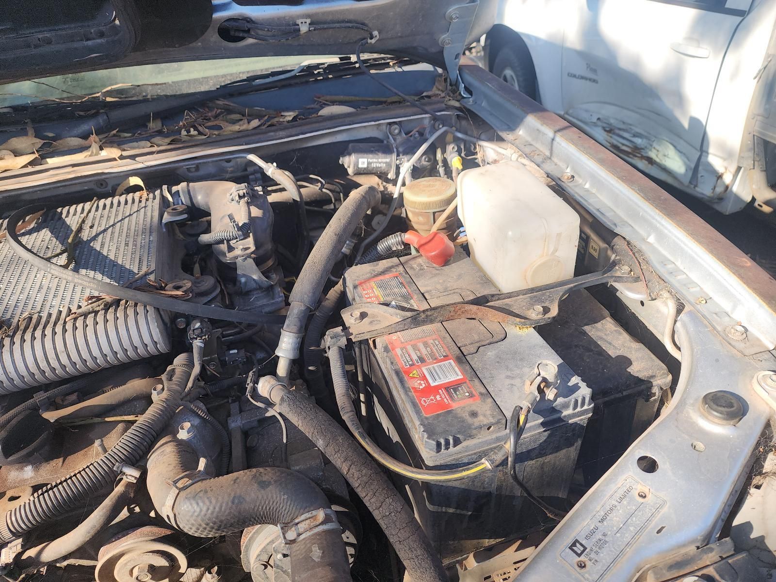 Car Engine Bay with Battery, Hoses, and Fluid Reservoir Under the Hood — South West 4WD Wreckers In Harristown, QLD