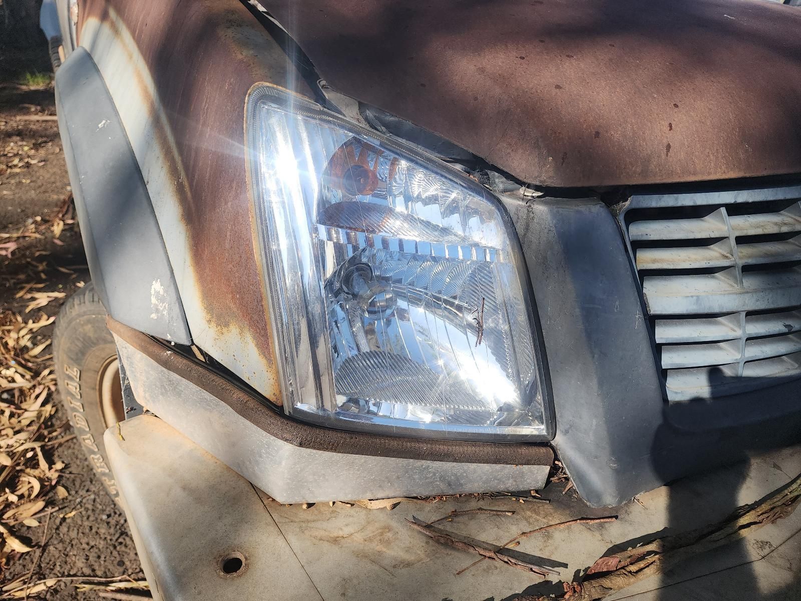 Close-Up of A Damaged Vehicle Front Bumper and Headlight — South West 4WD Wreckers In Harristown, QLD