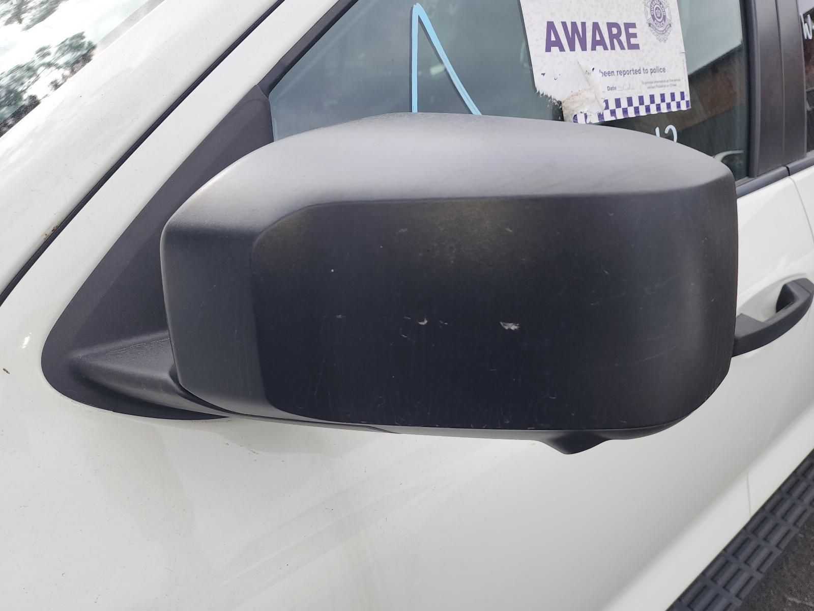 Black Side Mirror on a White Car, With an Aware Parking Tag — South West 4WD Wreckers In Harristown, QLD