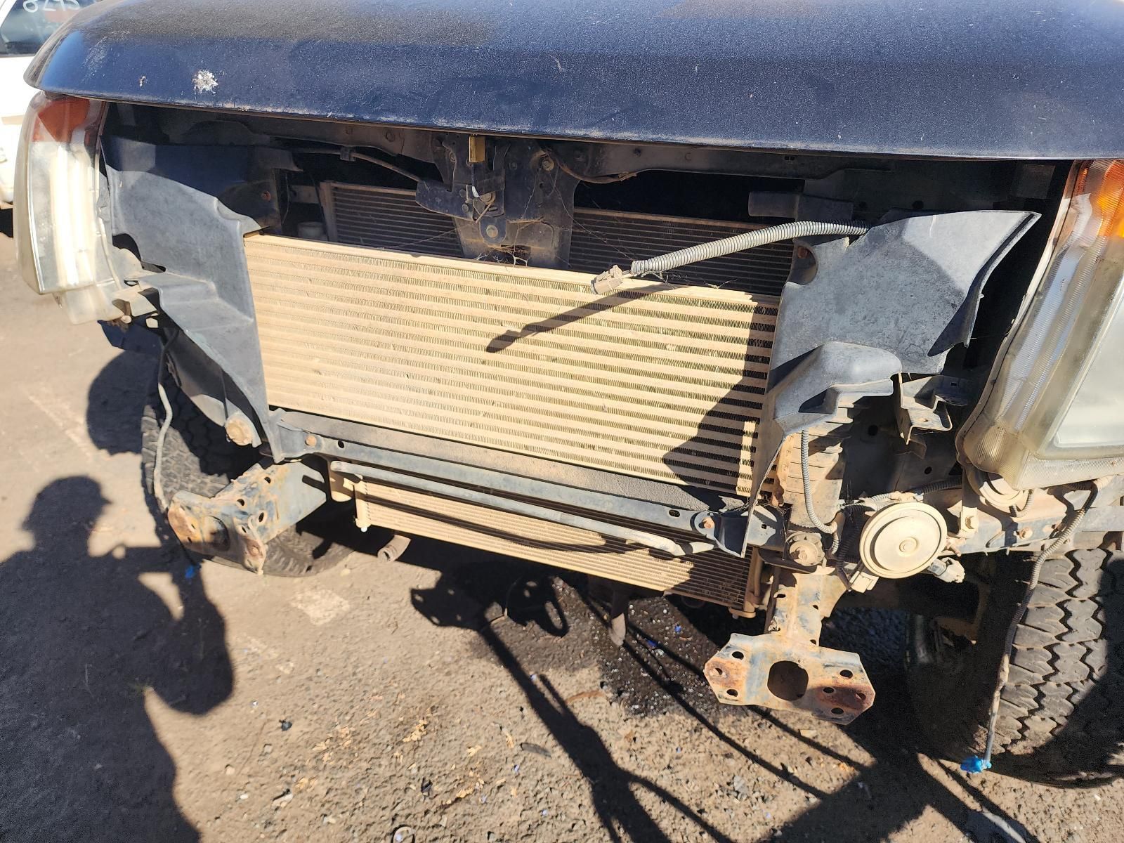 Front of a Black Vehicle With Severe Crash Damage — South West 4WD Wreckers In Harristown, QLD
