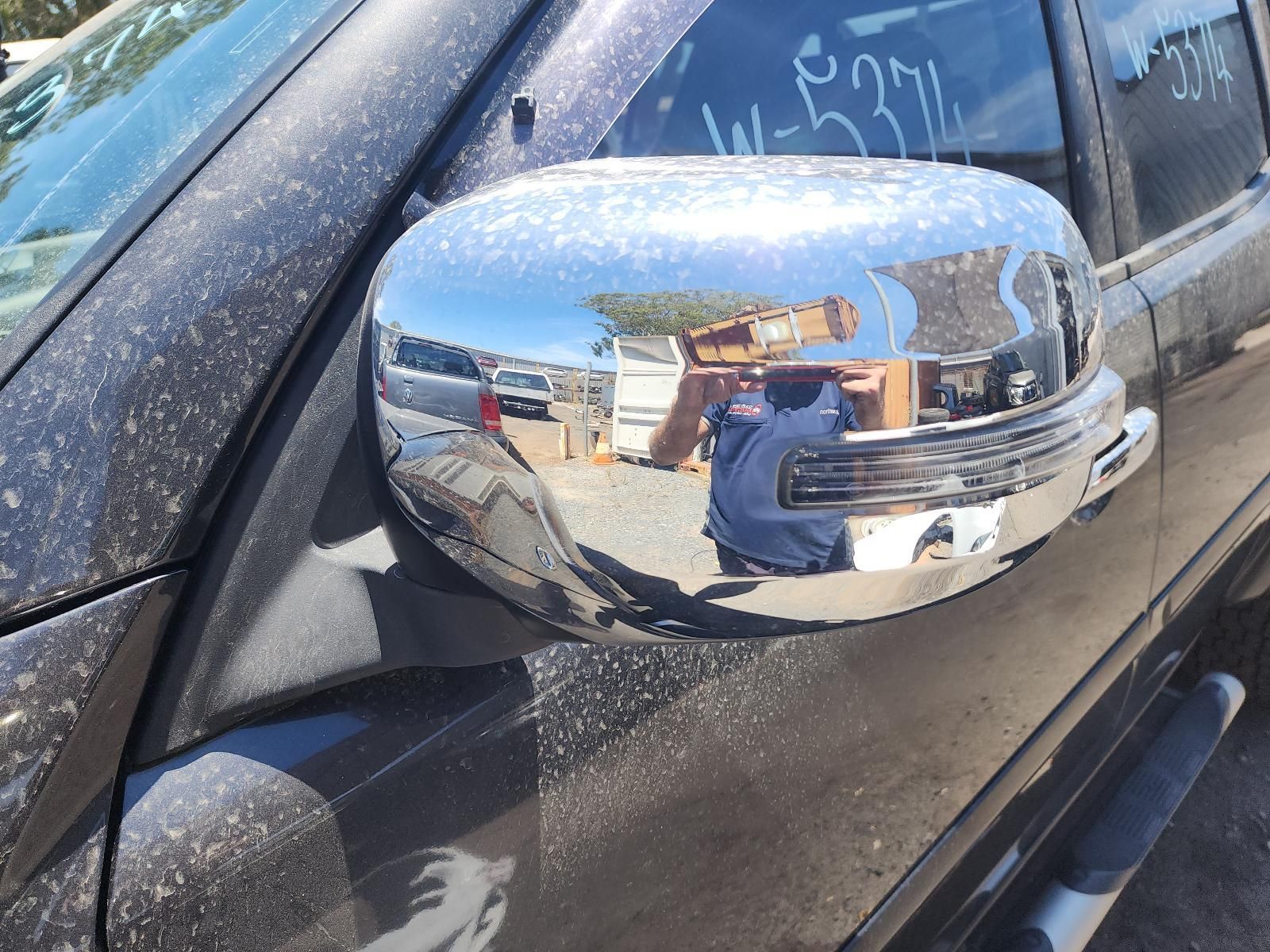 Chrome Side Mirror on a Black Vehicle, Reflecting a Person — South West 4WD Wreckers In Harristown, QLD
