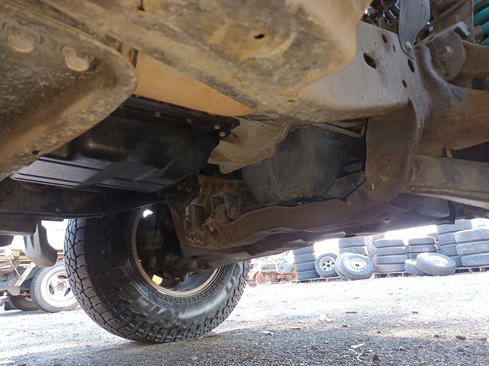 Undercarriage of An Off-Road Vehicle with A Large Tyre — South West 4WD Wreckers In Harristown, QLD