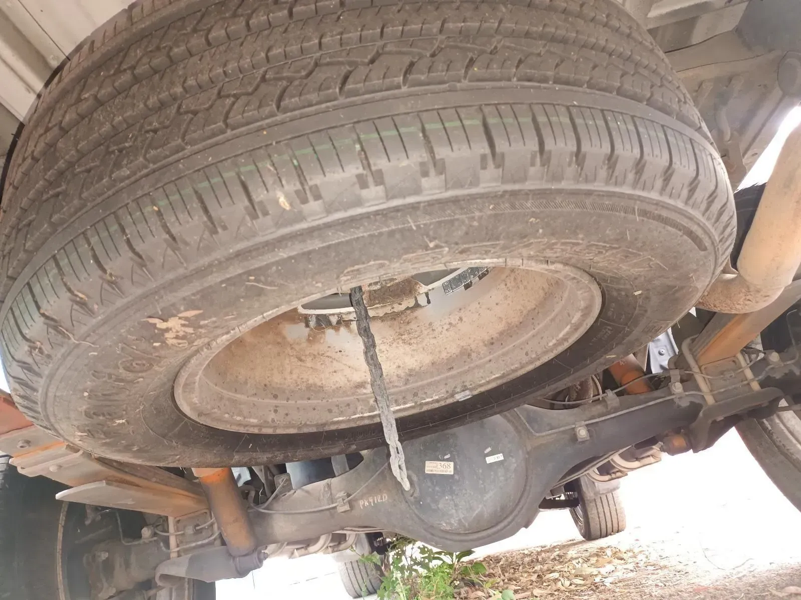Spare Tyre Mounted Under a Vehicle's Bed, Visible Rear Axle — South West 4WD Wreckers In Harristown, QLD