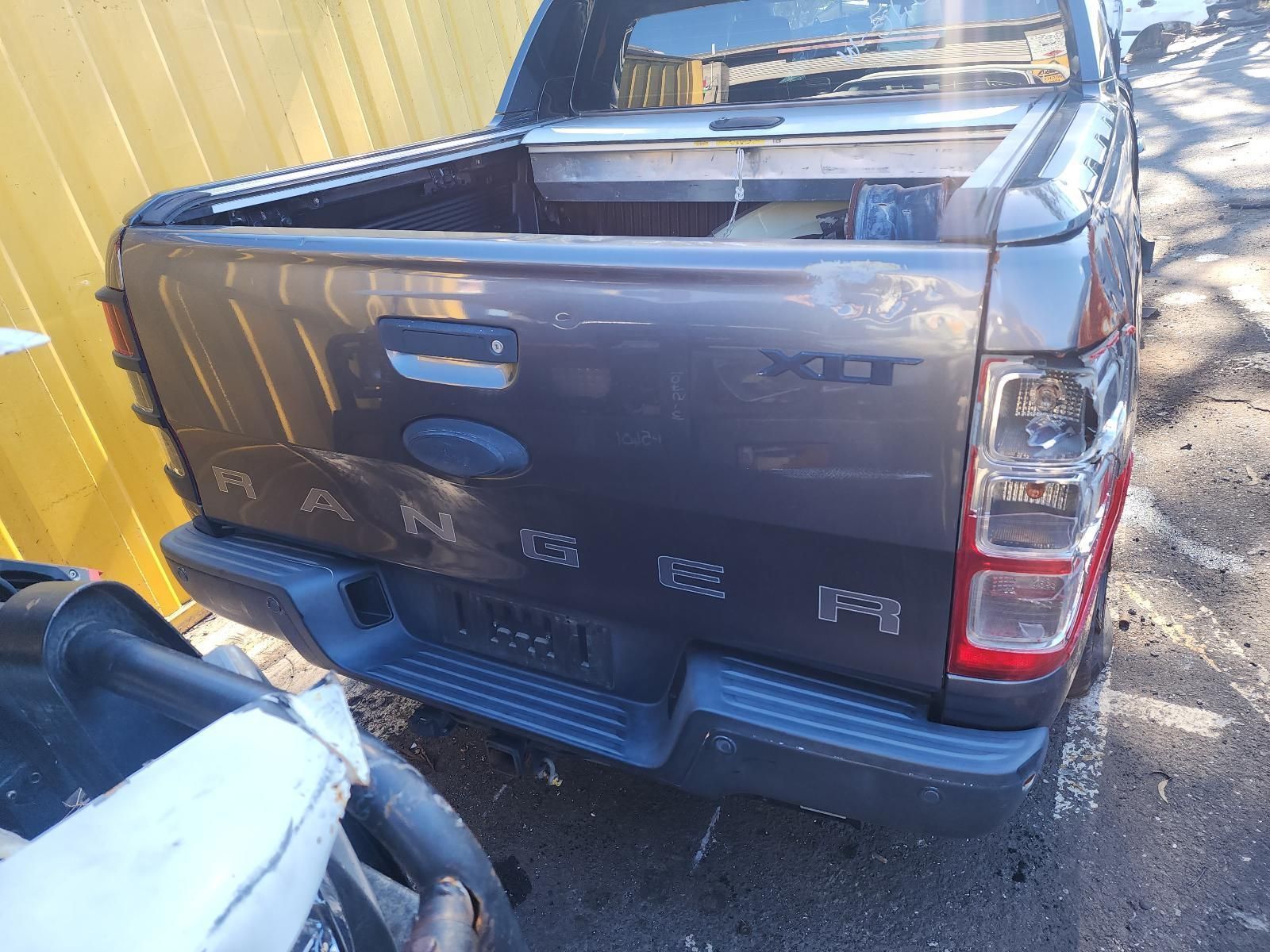 Dark Gray Pickup Truck Parked in a Narrow Driveway — South West 4WD Wreckers In Harristown, QLD