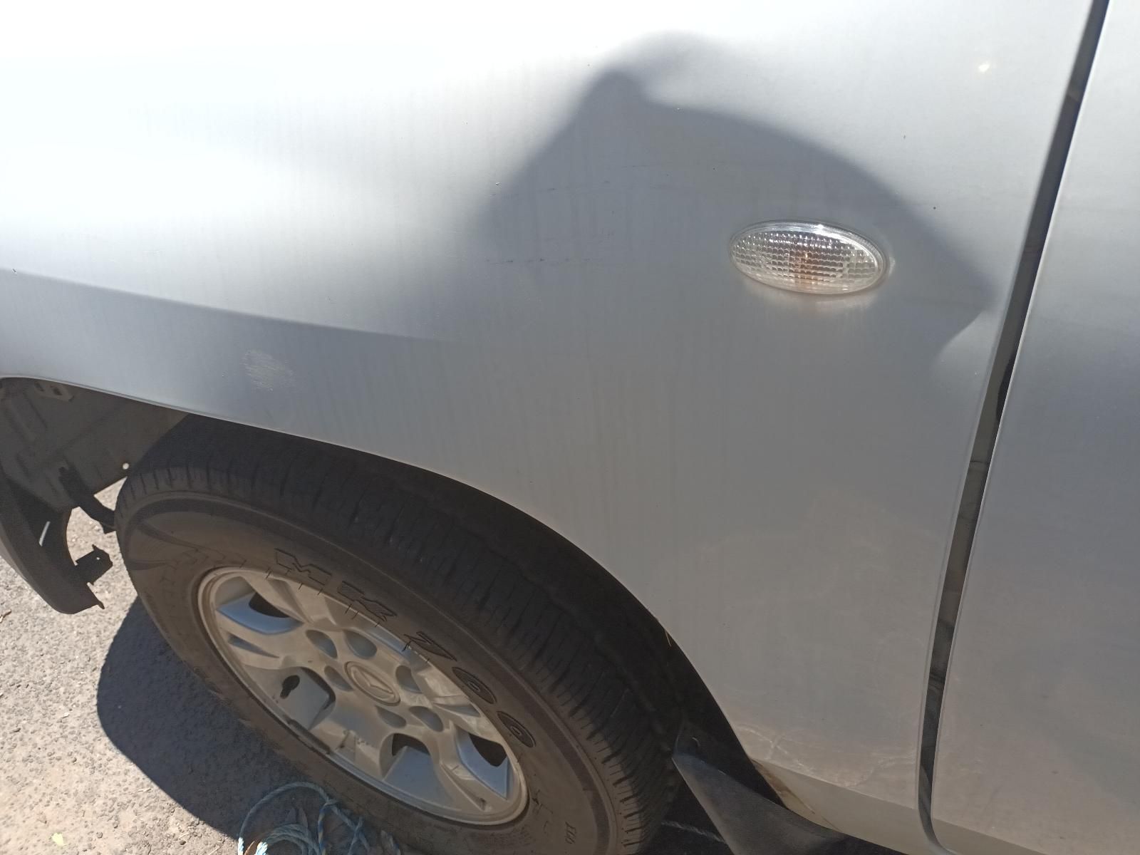 Close-Up of A Silver Car’s Front Wheel and Side Panel in Bright Sunlight — South West 4WD Wreckers In Harristown, QLD