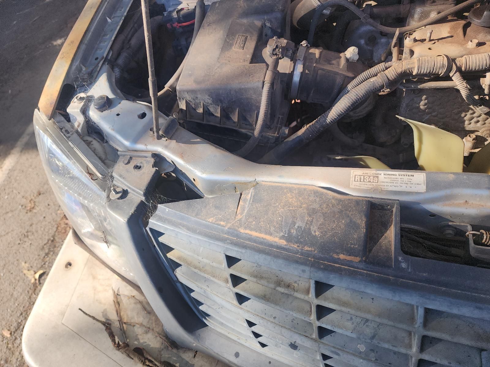 Damaged Front End of A Car with Exposed Engine Parts and Crushed Bumper — South West 4WD Wreckers In Harristown, QLD