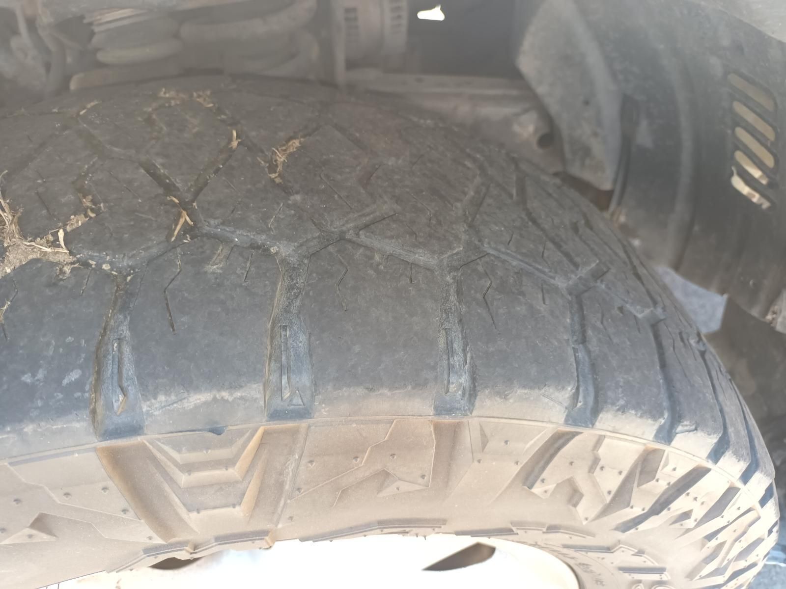 Close-Up of A Worn, Dusty Off-Road Tire Tread Inside a Vehicle Wheel Well — South West 4WD Wreckers In Harristown, QLD