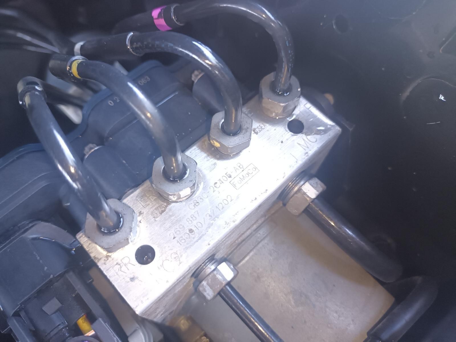 Close-Up of A Metal Hydraulic Manifold with Black Hoses — South West 4WD Wreckers In Harristown, QLD