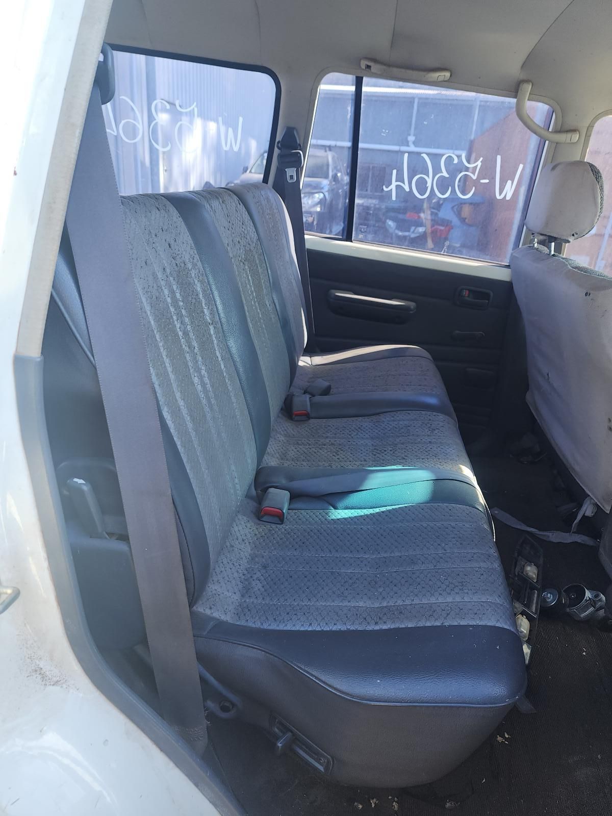 Back Seat of A White Van with Gray Bench Seats and Sunlight Through the Windows — South West 4WD Wreckers In Harristown, QLD