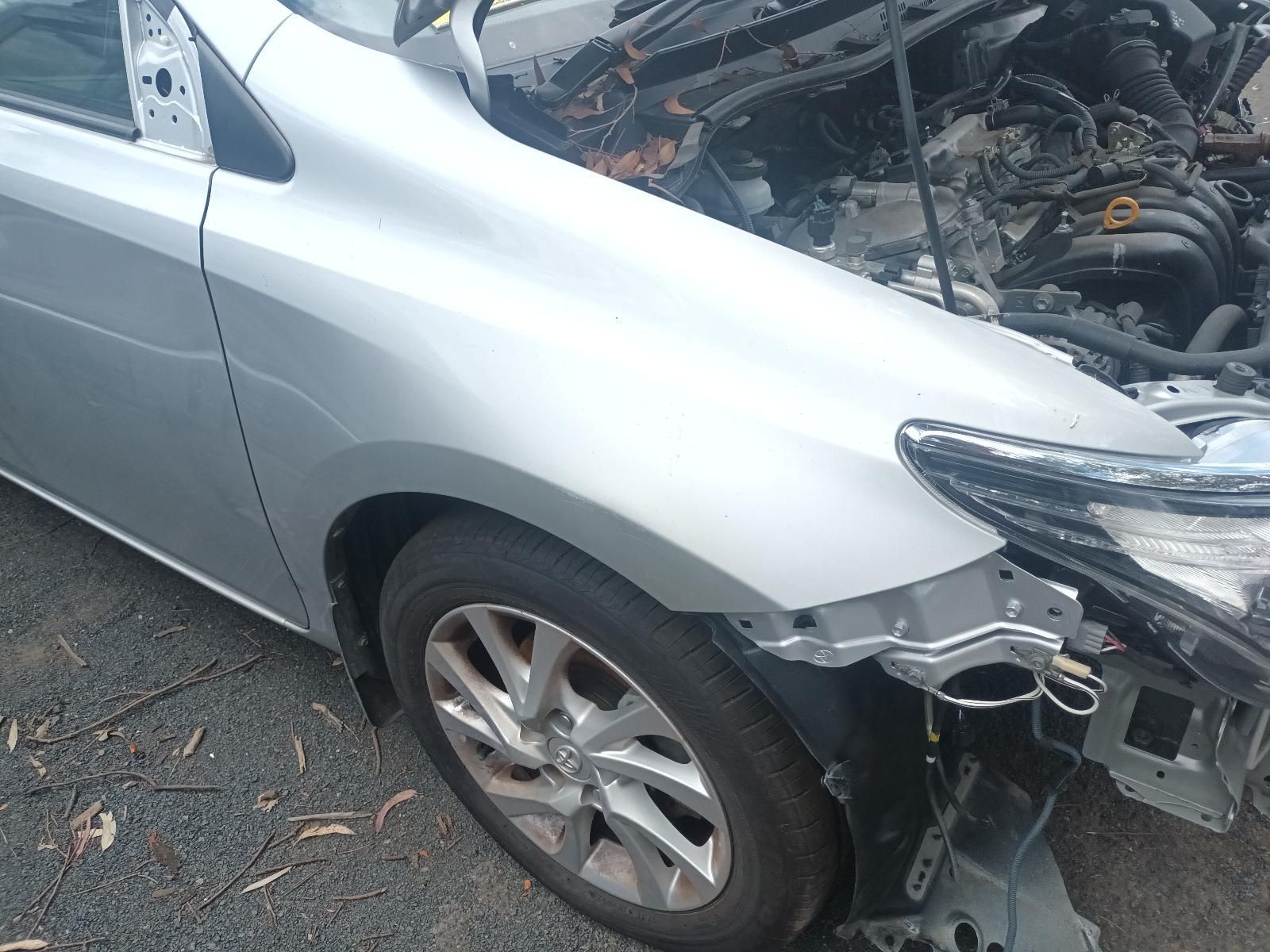 Silver Sedan with Front-End Damage, Missing Bumper, and Hood Open on A Street — South West 4WD Wreckers In Harristown, QLD