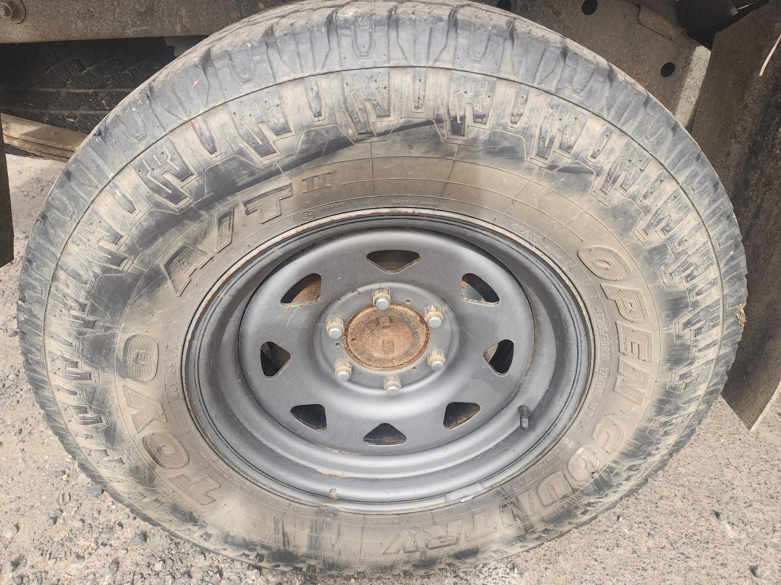 Dusty Car Tyre and Steel Wheel With Visible Rust on the Hub — South West 4WD Wreckers In Harristown, QLD