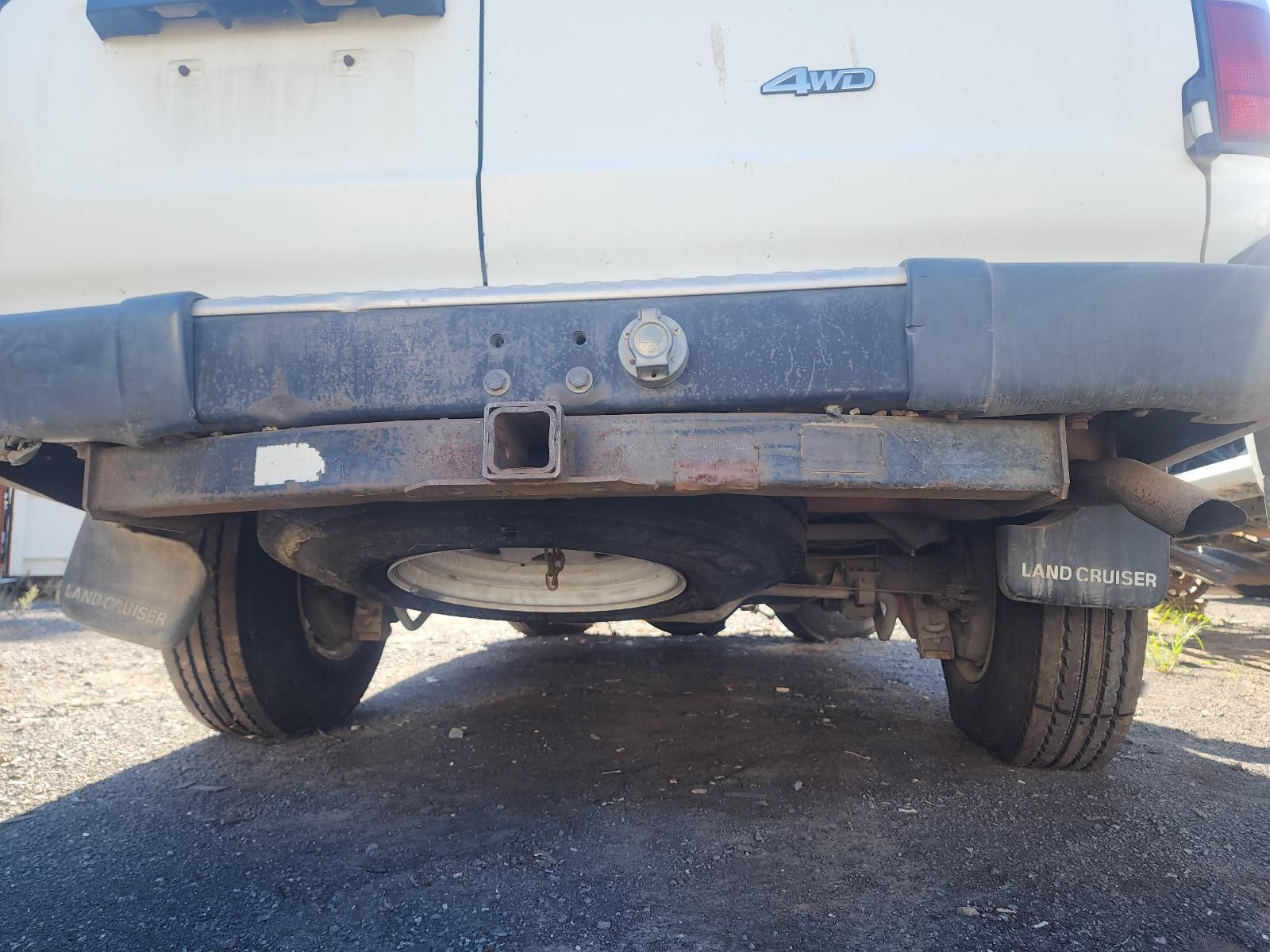 Rear View of A White Vehicle with A Damaged Black Bumper — South West 4WD Wreckers In Harristown, QLD