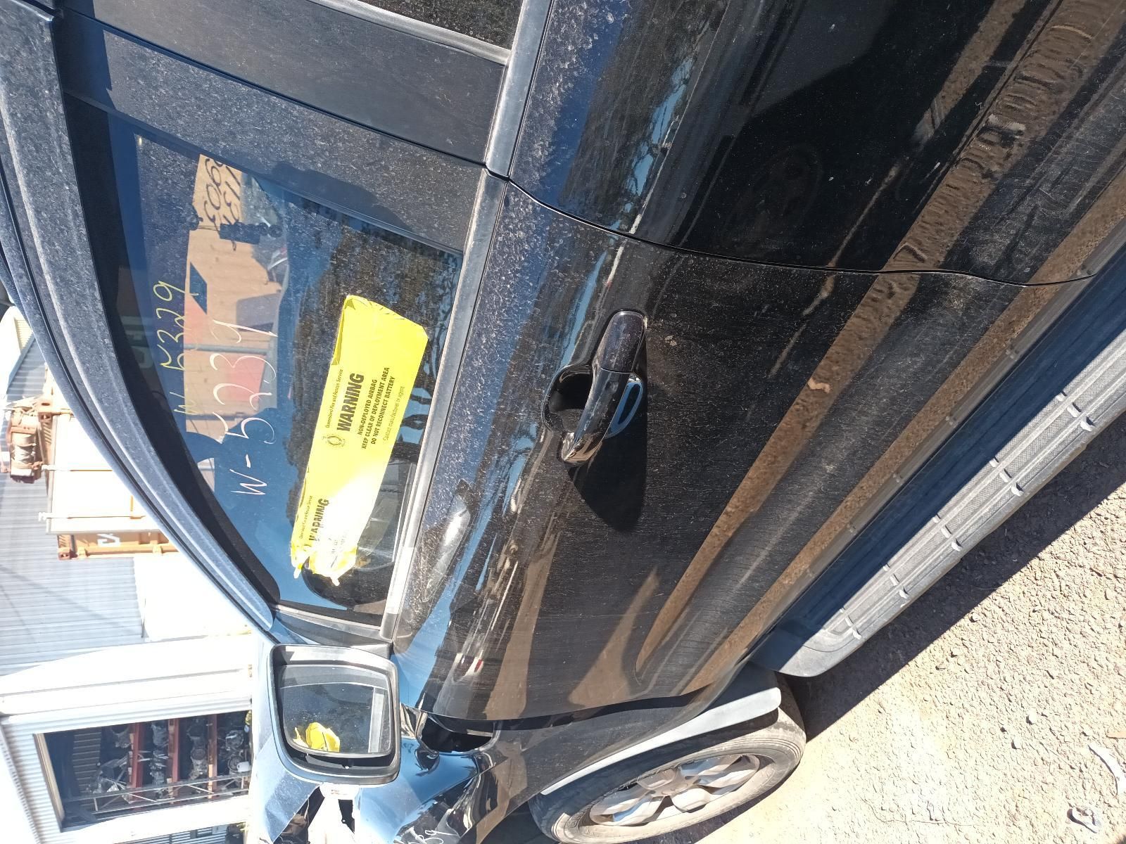 Black Car Parked Beside a Curb, Viewed Close-Up from The Side — South West 4WD Wreckers In Harristown, QLD