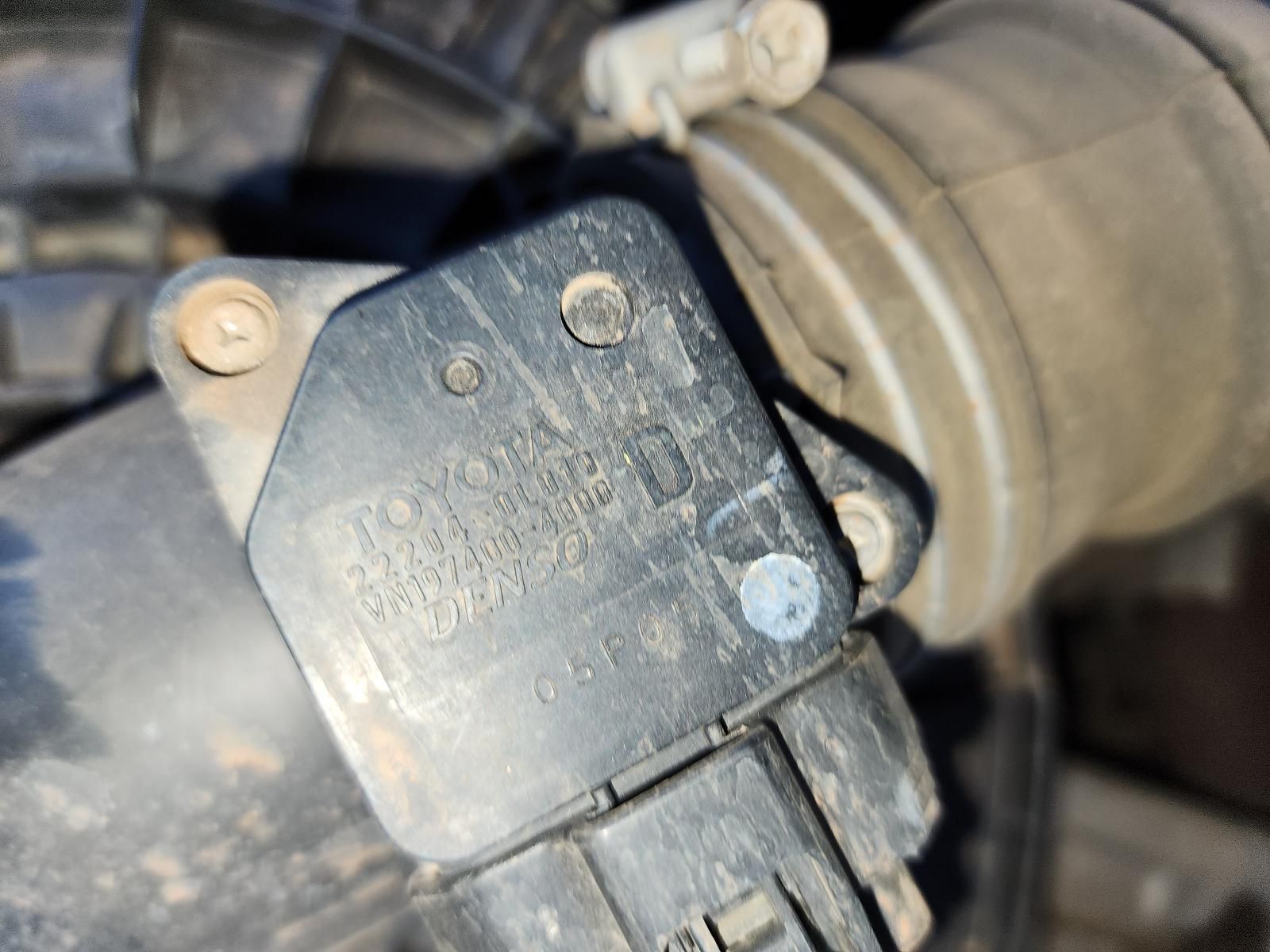 Close-up of a Dusty Black Engine Sensor — South West 4WD Wreckers In Harristown, QLD