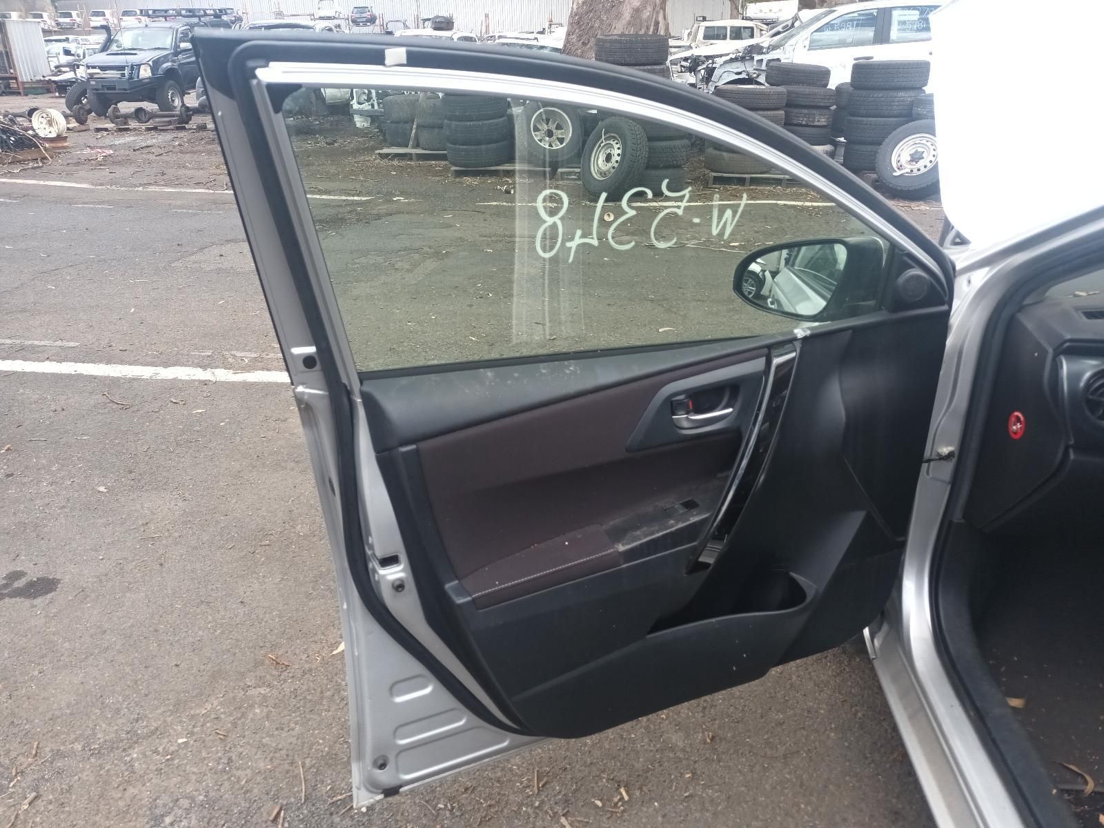 Open Car Door Showing Dark Interior in A Parking Lot with Other Vehicles — South West 4WD Wreckers In Harristown, QLD