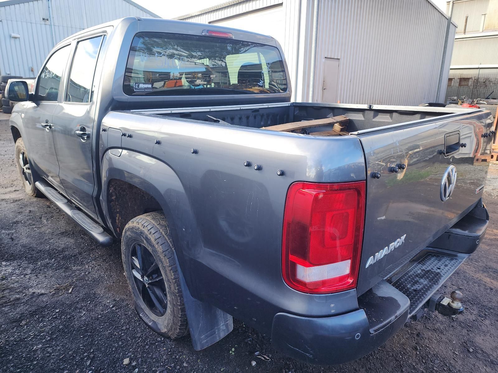 Dark Gray Pickup Truck Parked Beside a Metal Building — South West 4WD Wreckers In Harristown, QLD