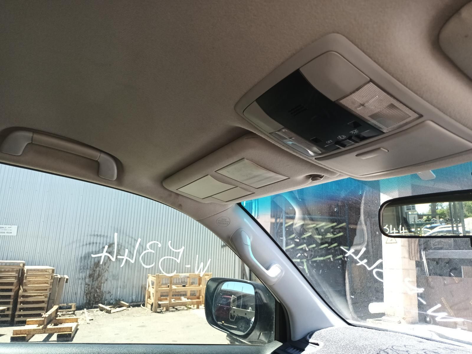 Car Interior Facing a Warehouse Yard with Stacked Wooden Pallets — South West 4WD Wreckers In Harristown, QLD