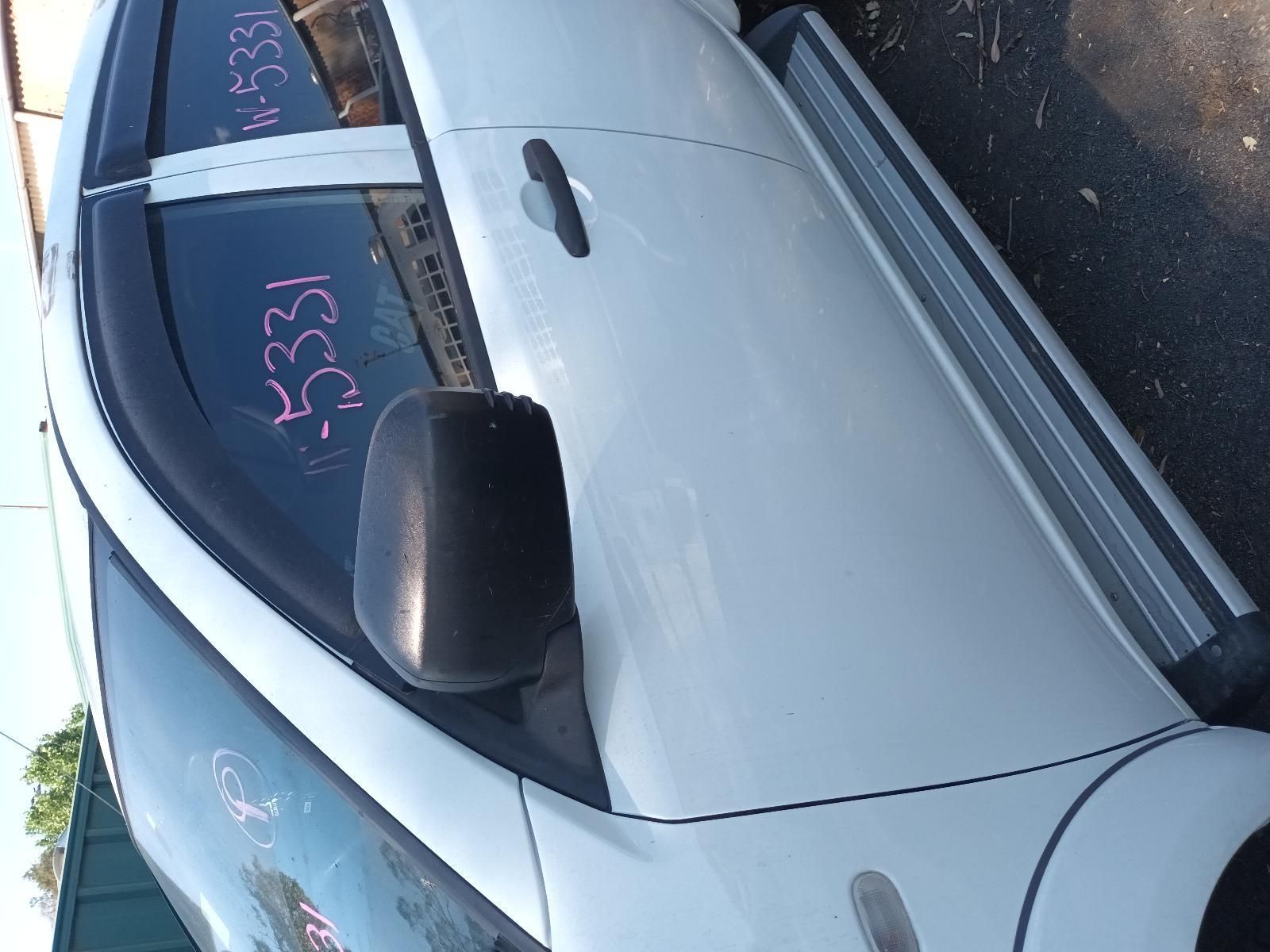 Silver Car with Pink Writing on The Windshield, Parked Outdoors Near a Curb — South West 4WD Wreckers In Harristown, QLD