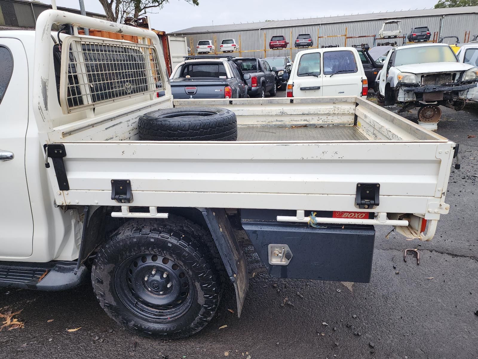 White Flatbed Truck Parked in a Lot, Rear Side View — South West 4WD Wreckers In Harristown, QLD
