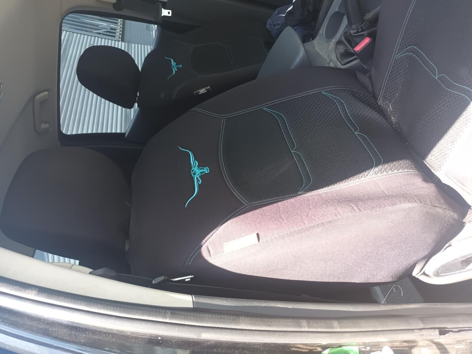 Back Seat of A Car with Two Black Child Car Seats, One Showing Teal Stitching — South West 4WD Wreckers In Harristown, QLD