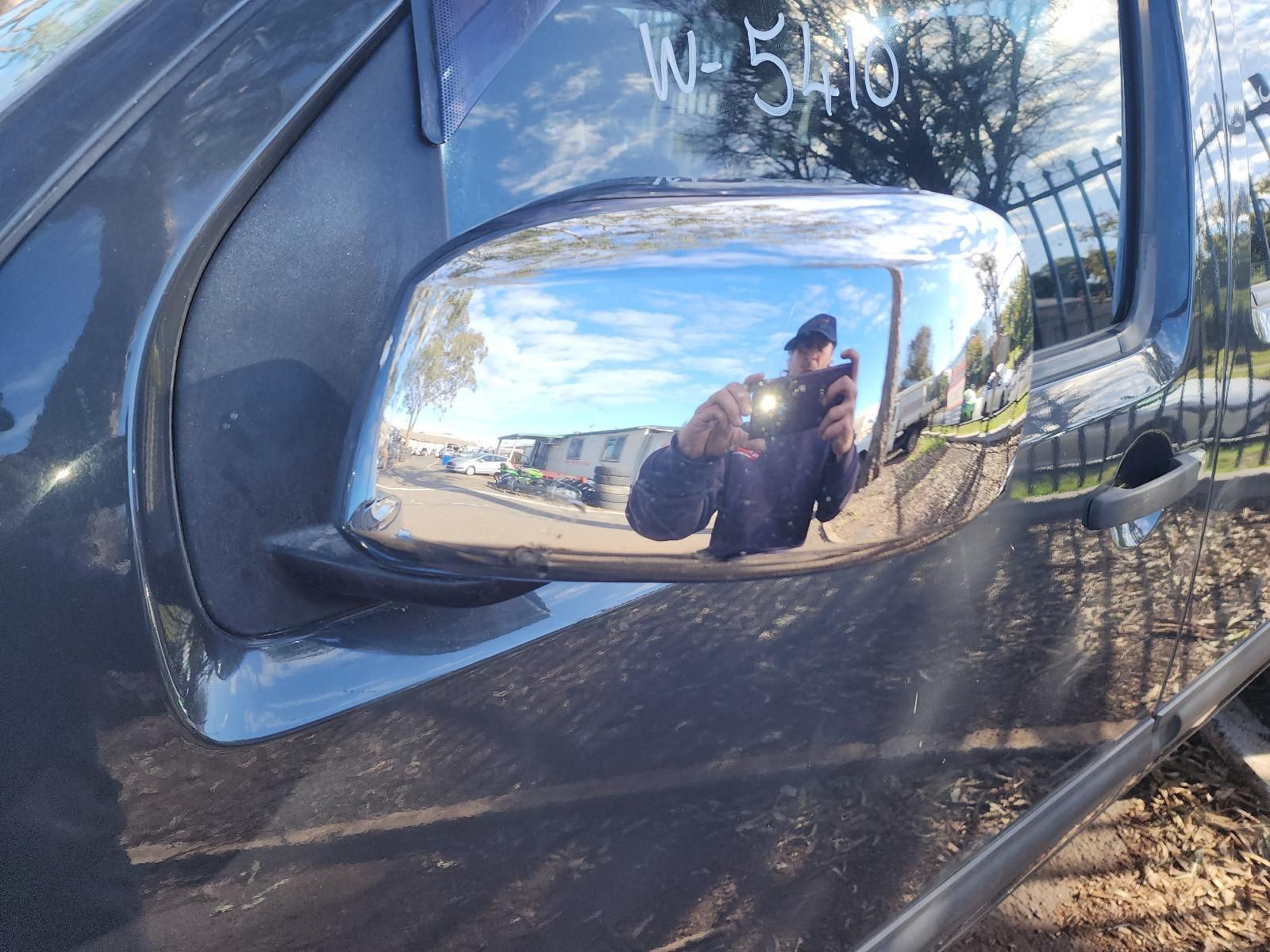 Close-up of a Black Car’s Side Mirror Reflecting a Person — South West 4WD Wreckers In Harristown, QLD