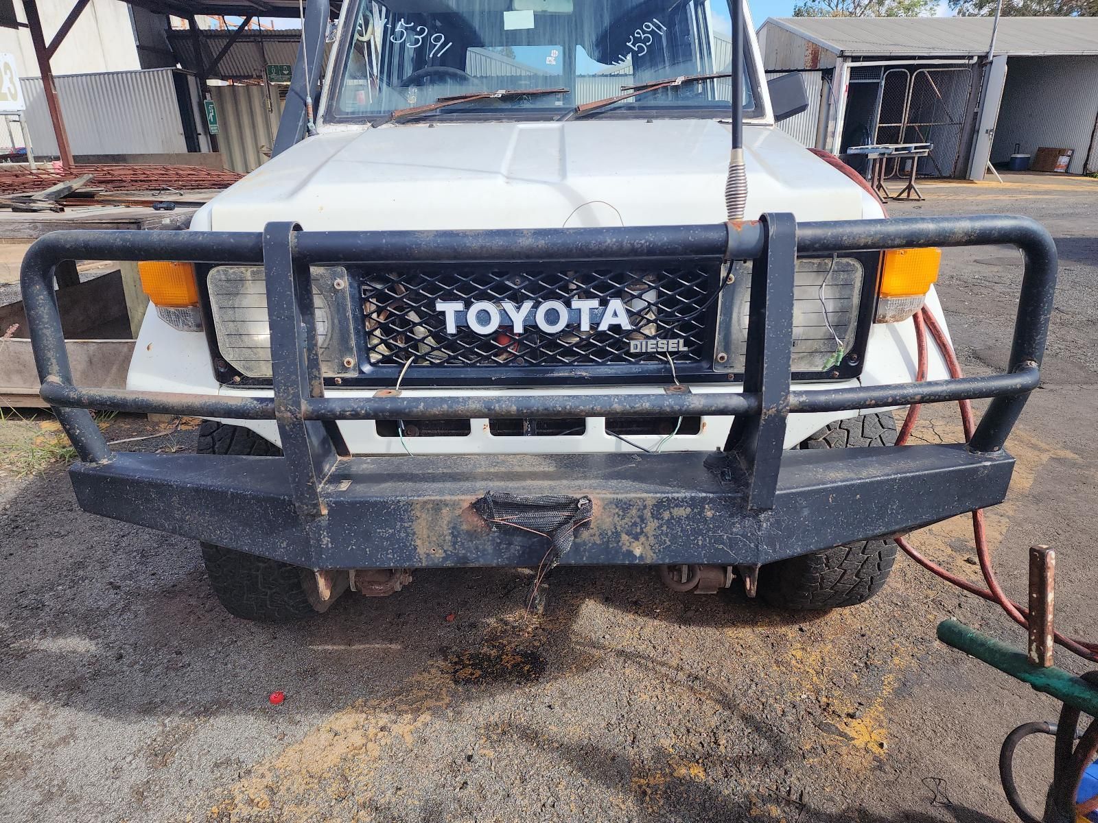 White Toyota Truck With a Black Front Grille Guard — South West 4WD Wreckers In Harristown, QLD
