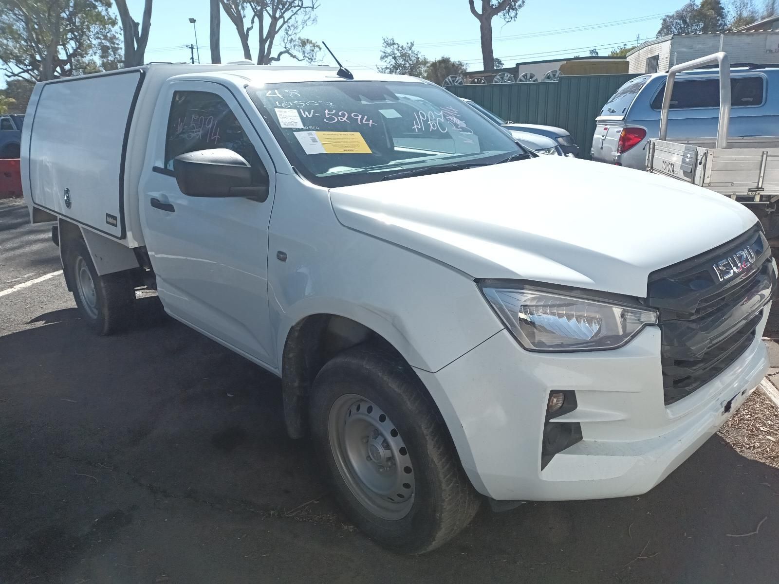 A Silver Nissan Pickup Truck is Parked in Front of a Building — South West 4WD Wreckers In Brisbane, QLD