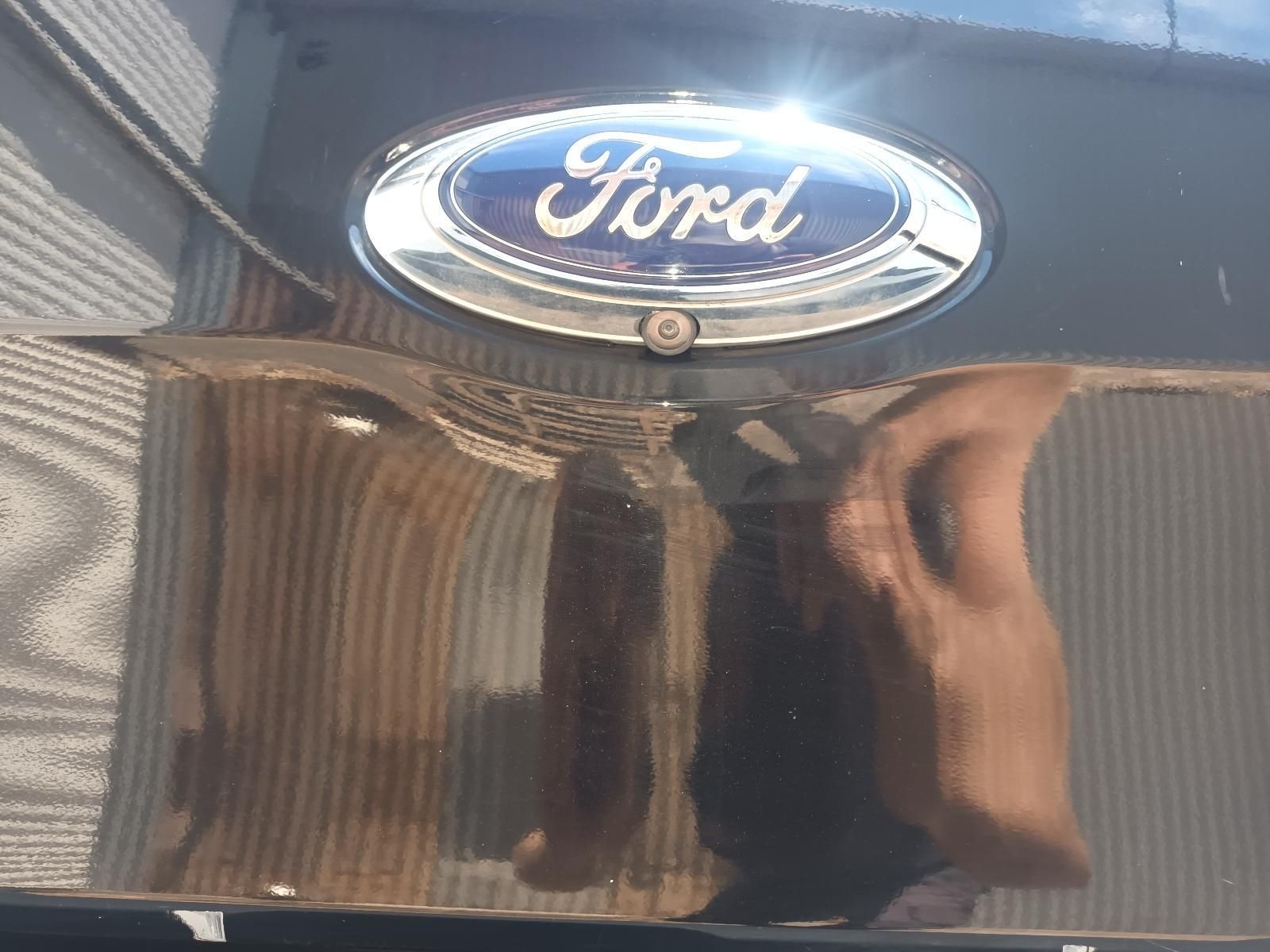 Close-Up of A Ford Emblem on A Glossy Black Vehicle Hatch — South West 4WD Wreckers In Harristown, QLD