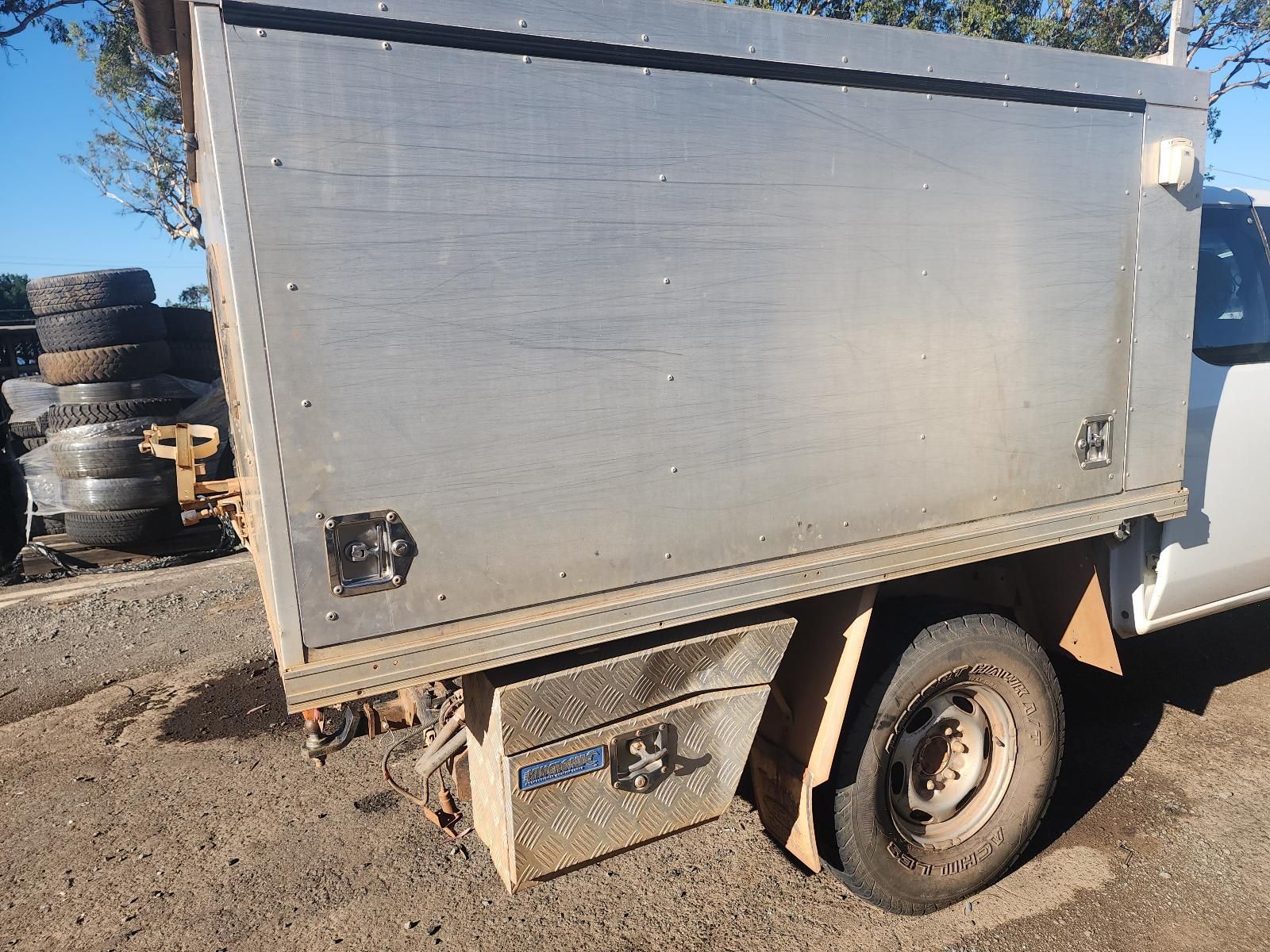 Small Gray Utility Trailer Parked on a Dirt Lot — South West 4WD Wreckers In Harristown, QLD