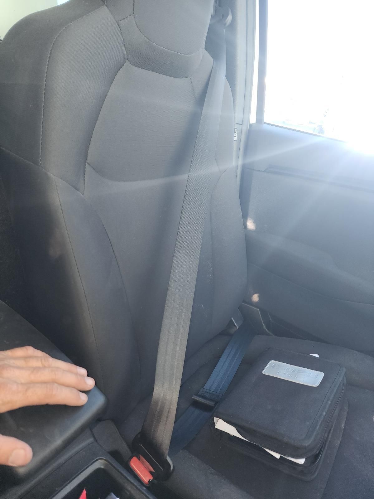 Car Interior With Seatbelt, a Hand on the Armrest — South West 4WD Wreckers In Harristown, QLD
