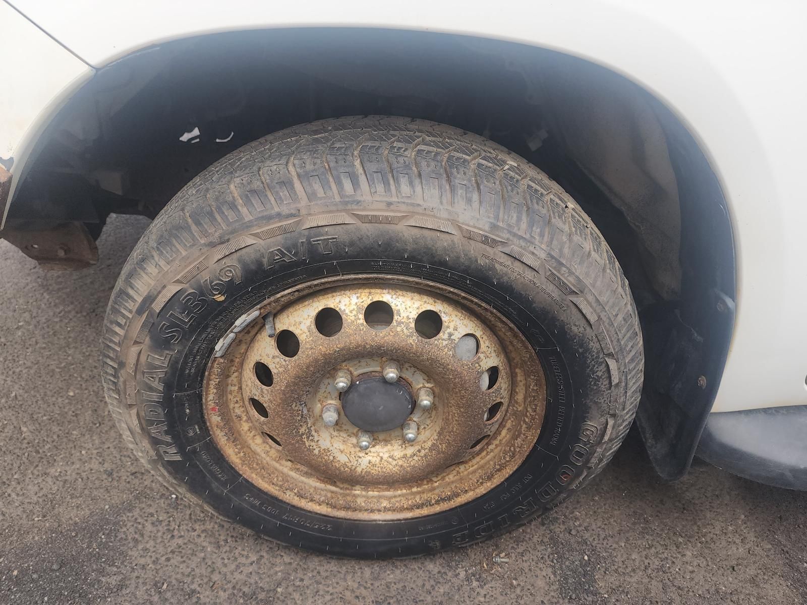 Close-up of a Dirty Car Tyre and Rusted Steel Wheel — South West 4WD Wreckers In Harristown, QLD