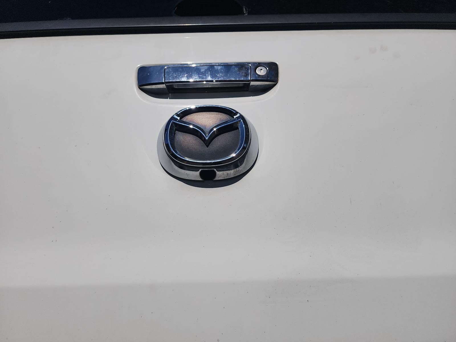 Close-up of a Chrome Mazda Emblem — South West 4WD Wreckers In Harristown, QLD