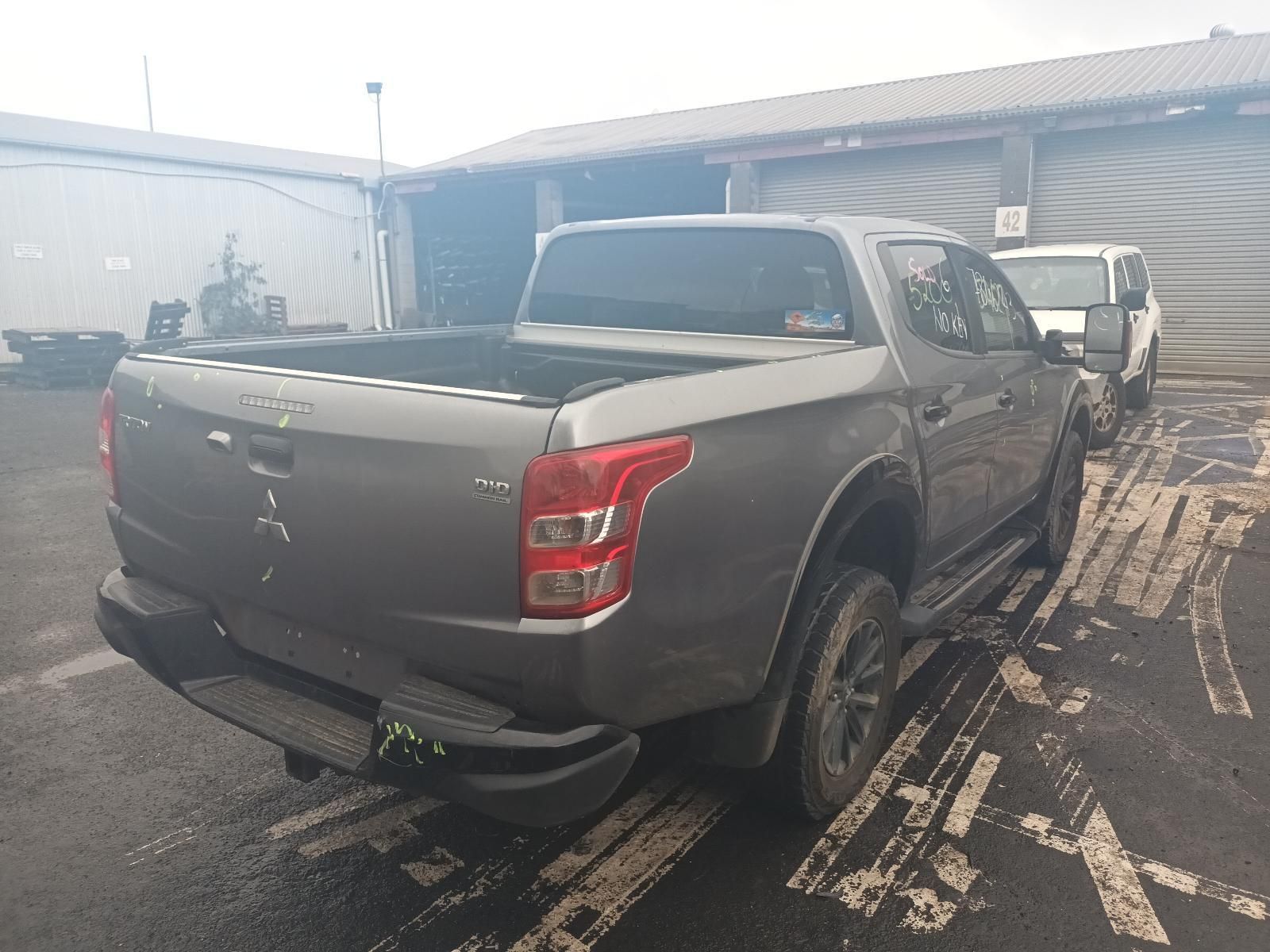 A Gray Truck is Parked in a Parking Lot in Front of a Building — South West 4WD Wreckers In Brisbane, QLD