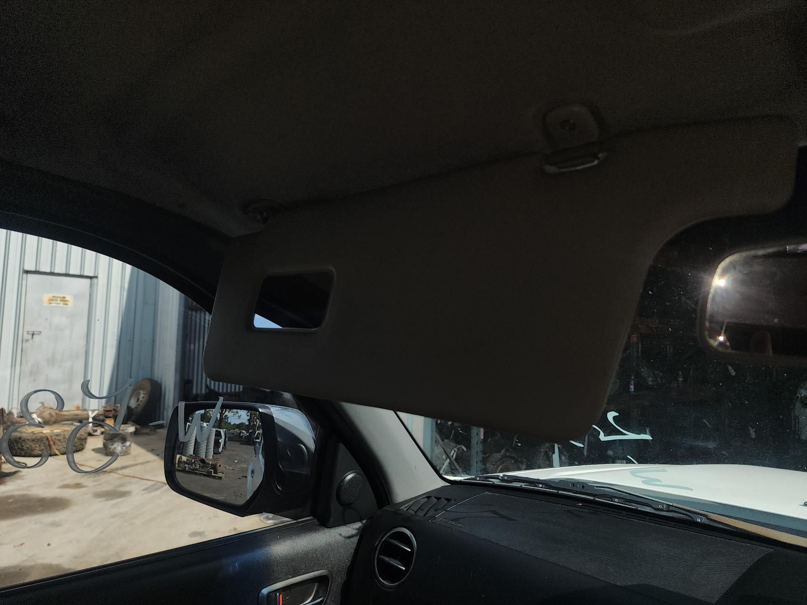 Car Interior Facing a Sunlit Metal Gate Outside — South West 4WD Wreckers In Harristown, QLD
