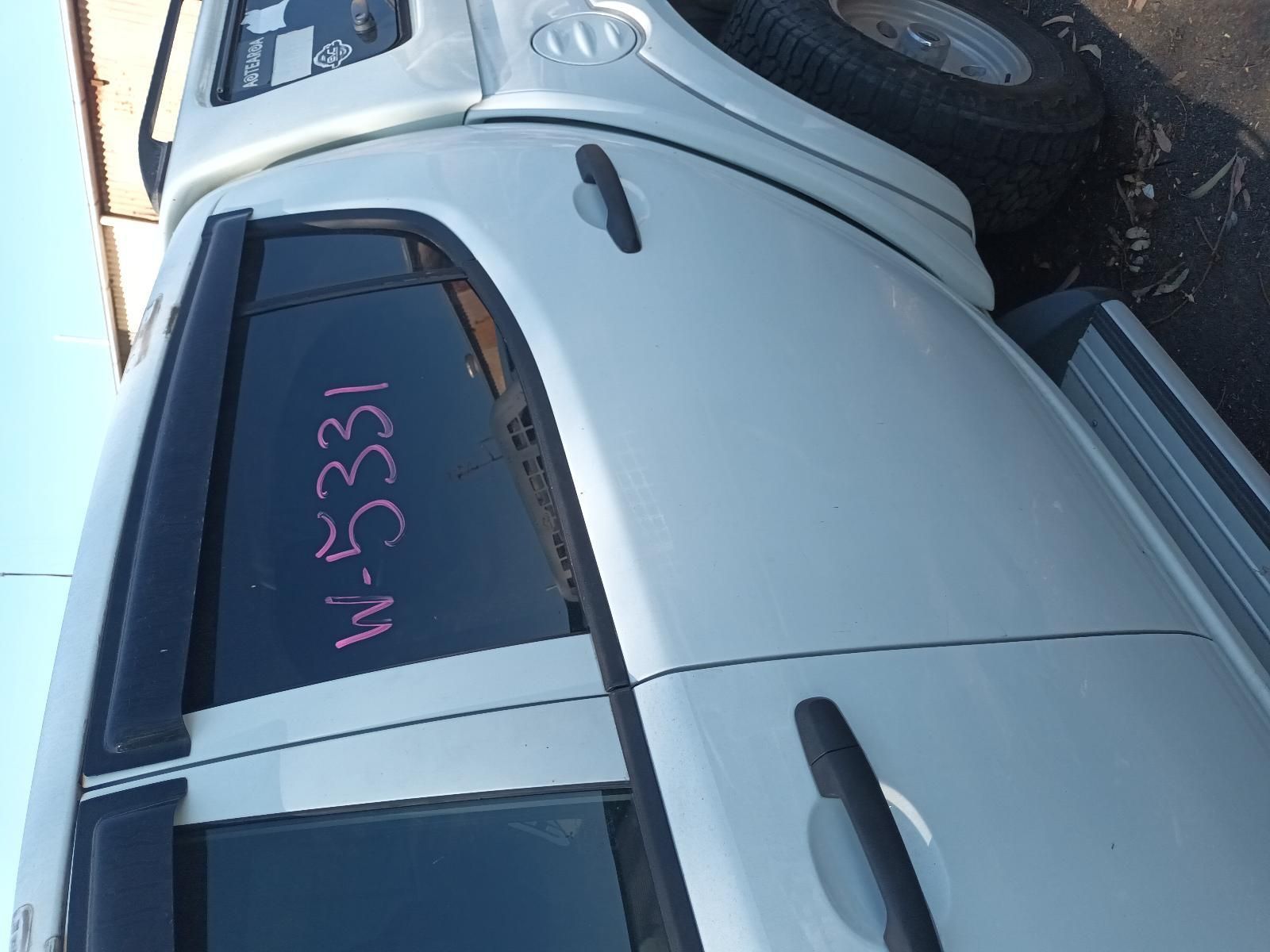 Silver Car with Pink Numbers Written on The Rear Window, Parked Outdoors — South West 4WD Wreckers In Harristown, QLD