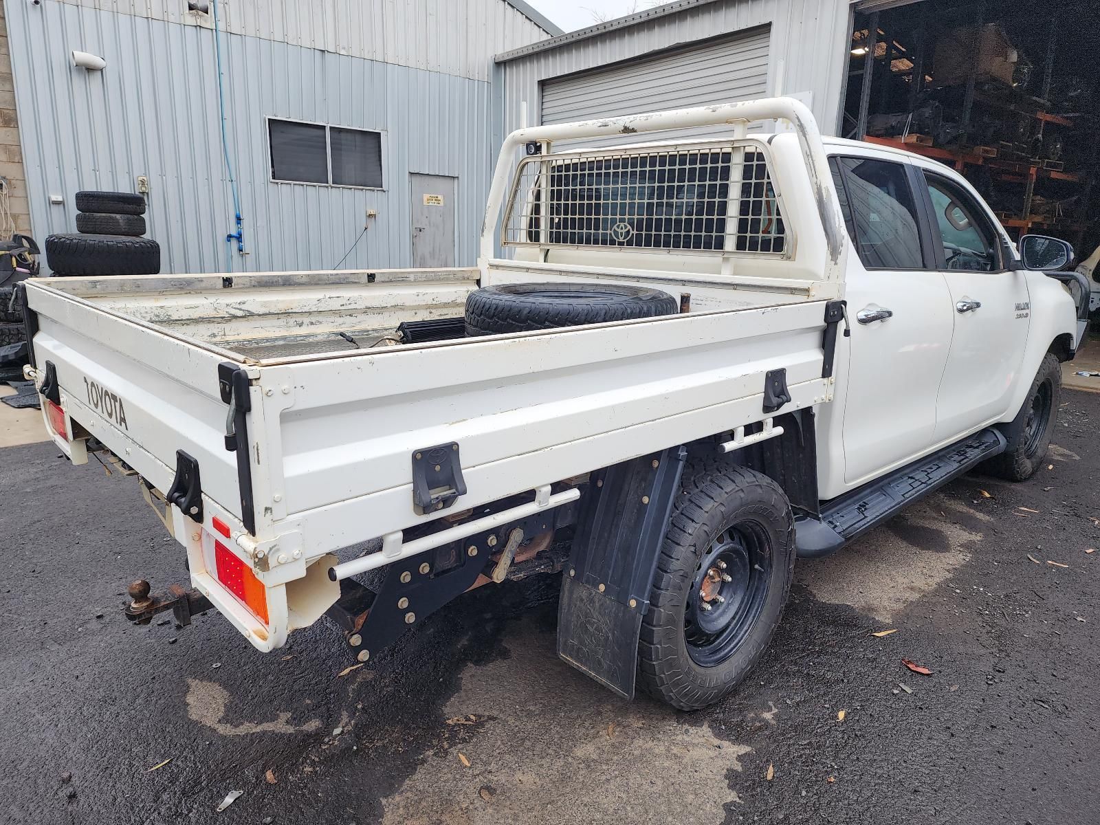 White Flatbed Pickup Truck Parked Beside — South West 4WD Wreckers In Harristown, QLD