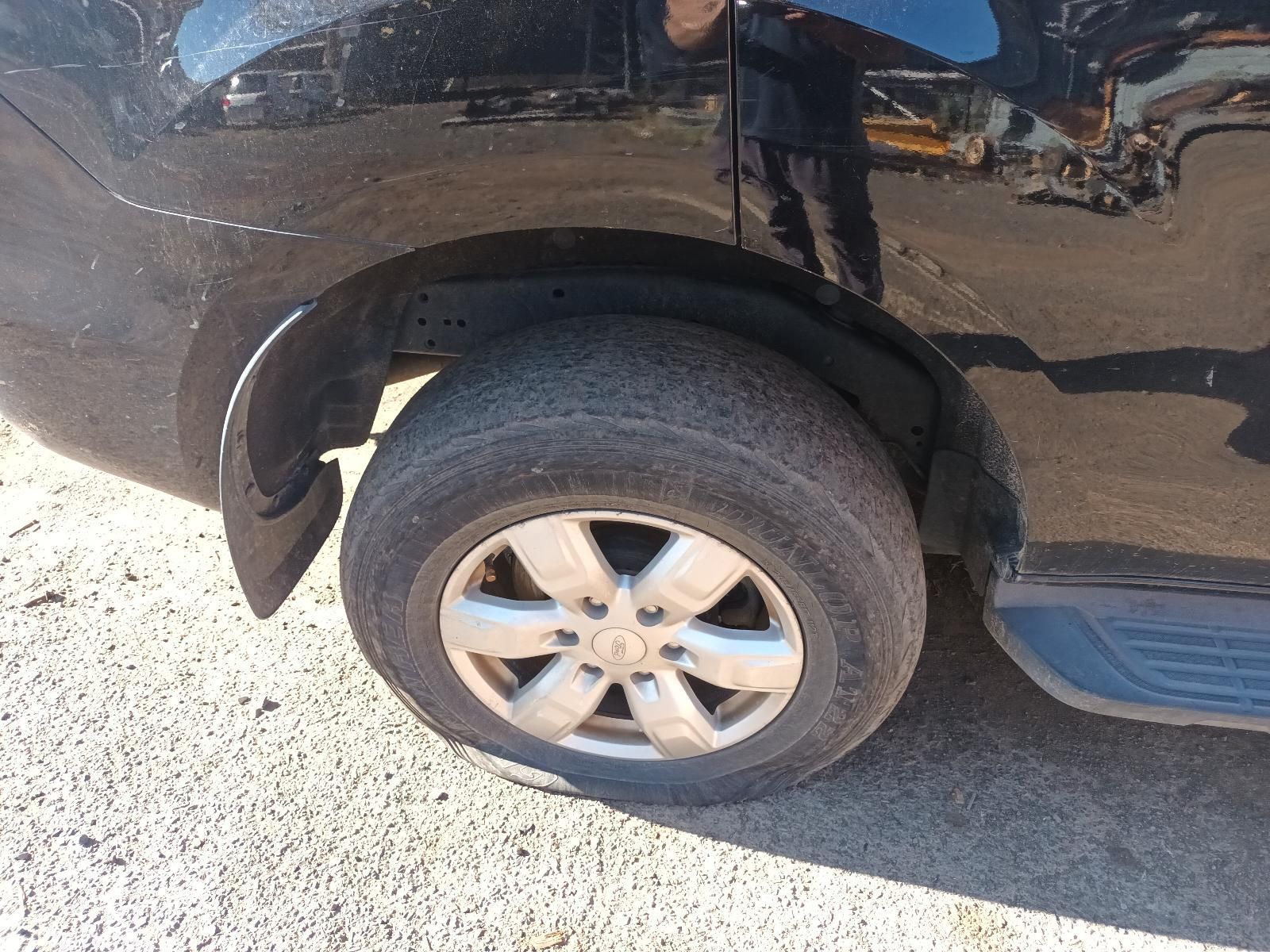 Close-Up of A Black Car’s Rear Wheel and Fender — South West 4WD Wreckers In Harristown, QLD