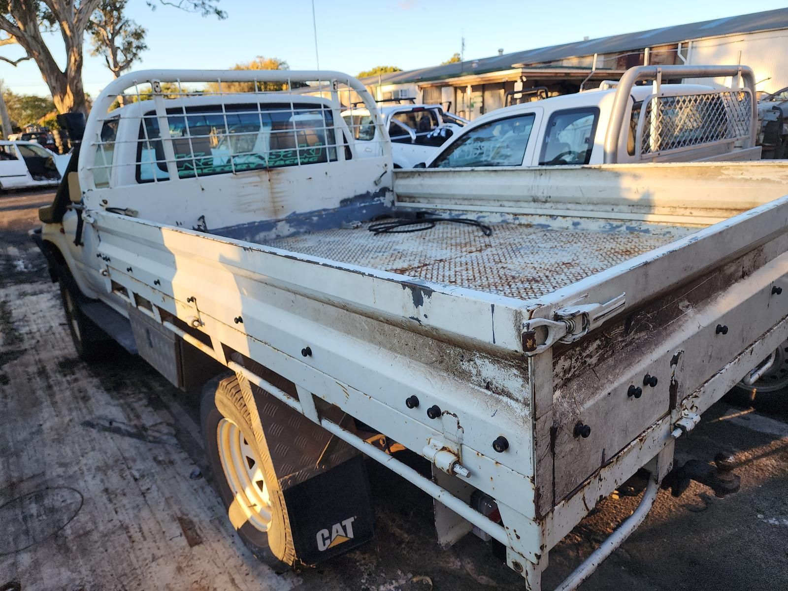 White Flatbed Truck Parked in a Lot — South West 4WD Wreckers In Harristown, QLD
