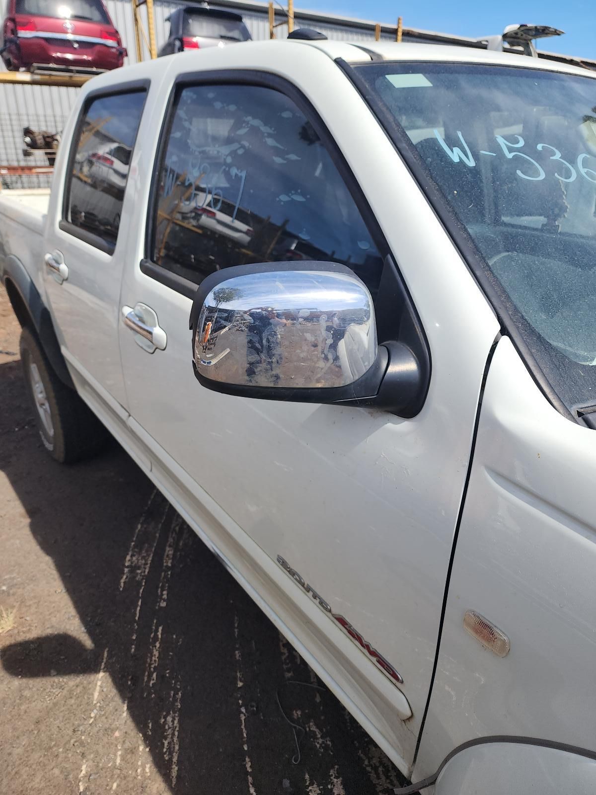 White Pickup Truck With Chrome Side Mirror Parked in a Lot — South West 4WD Wreckers In Harristown, QLD