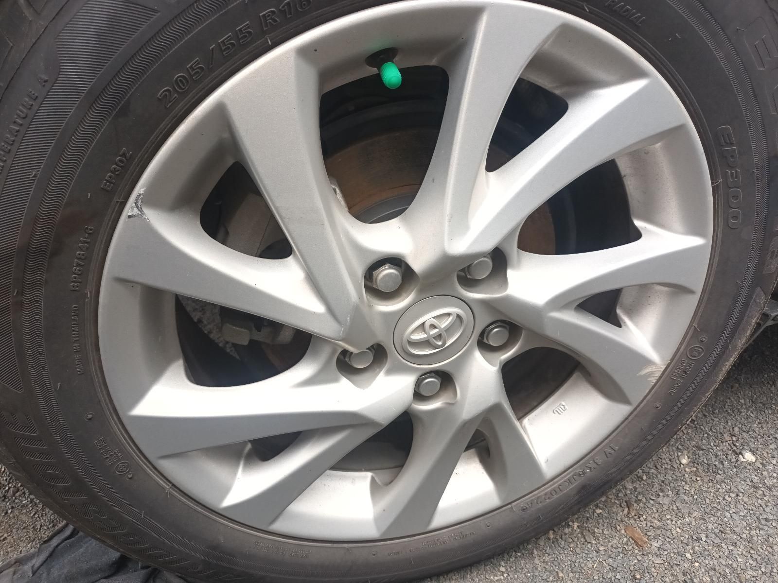 Close-up of a car wheel with a silver Toyota alloy rim and black tyre — South West 4WD Wreckers In Harristown, QLD