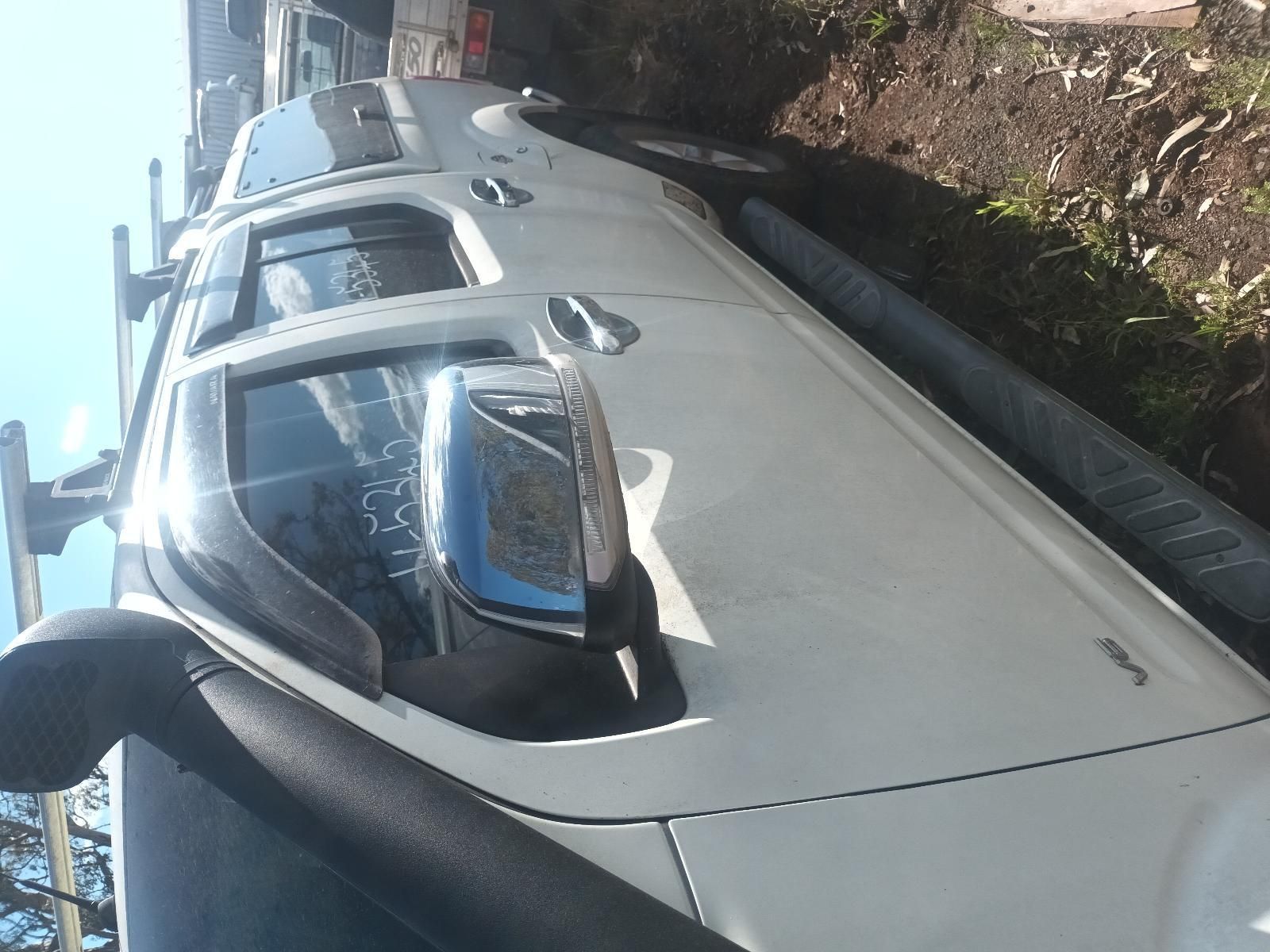 Silver Car Parked Curbside with Its Windshield Reflecting the Sky — South West 4WD Wreckers In Harristown, QLD