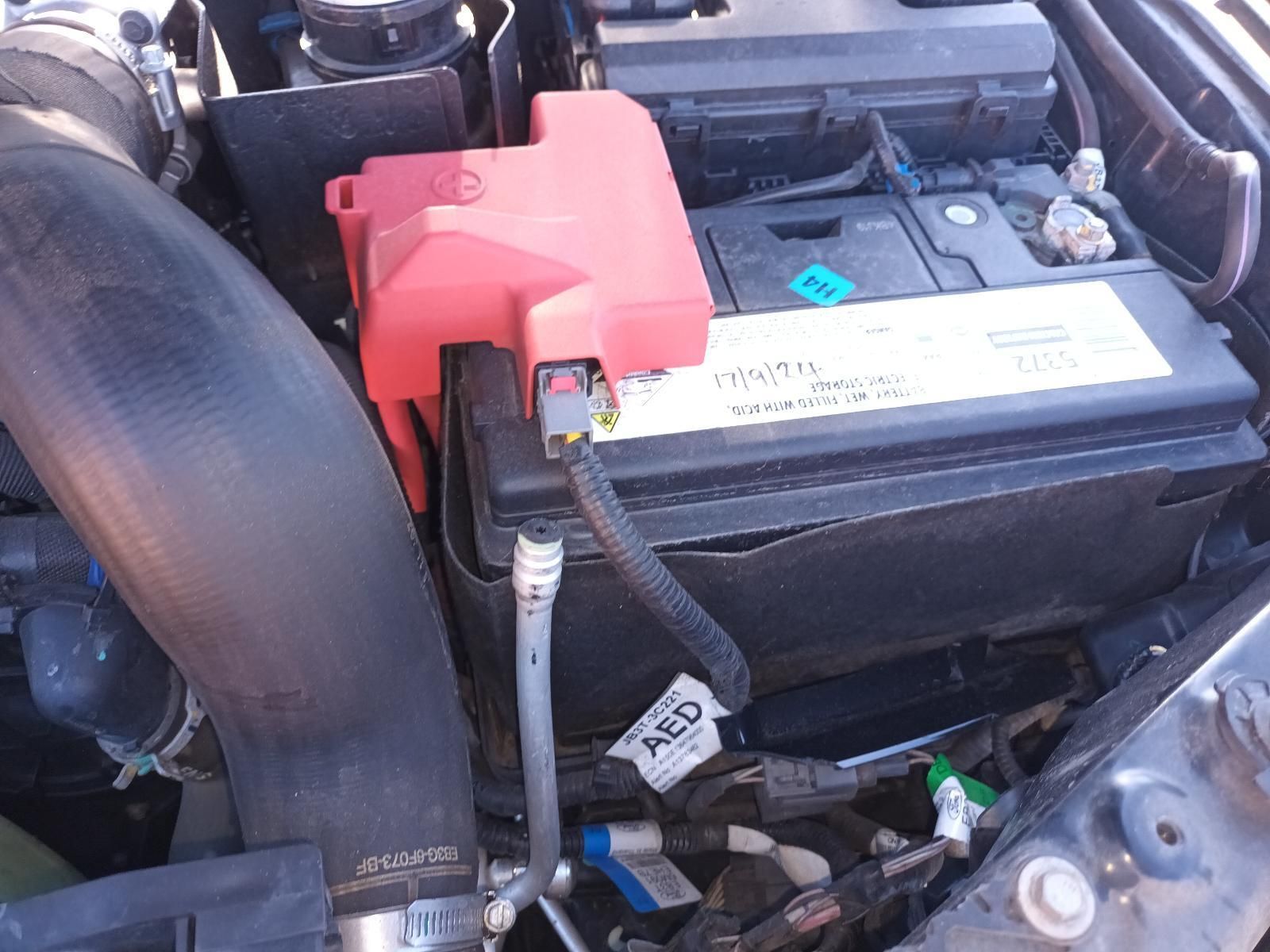 Car Battery with Red Terminal Cover in An Engine Bay — South West 4WD Wreckers In Harristown, QLD