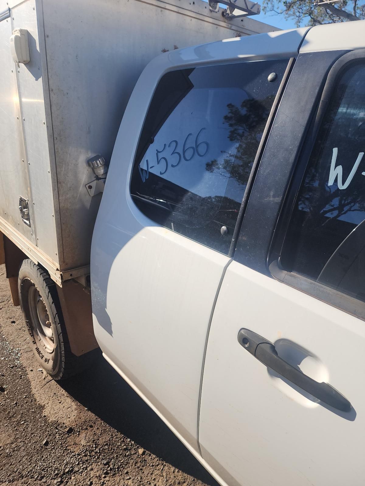 White SUV With a Dented Rear Side Panel Parked — South West 4WD Wreckers In Harristown, QLD