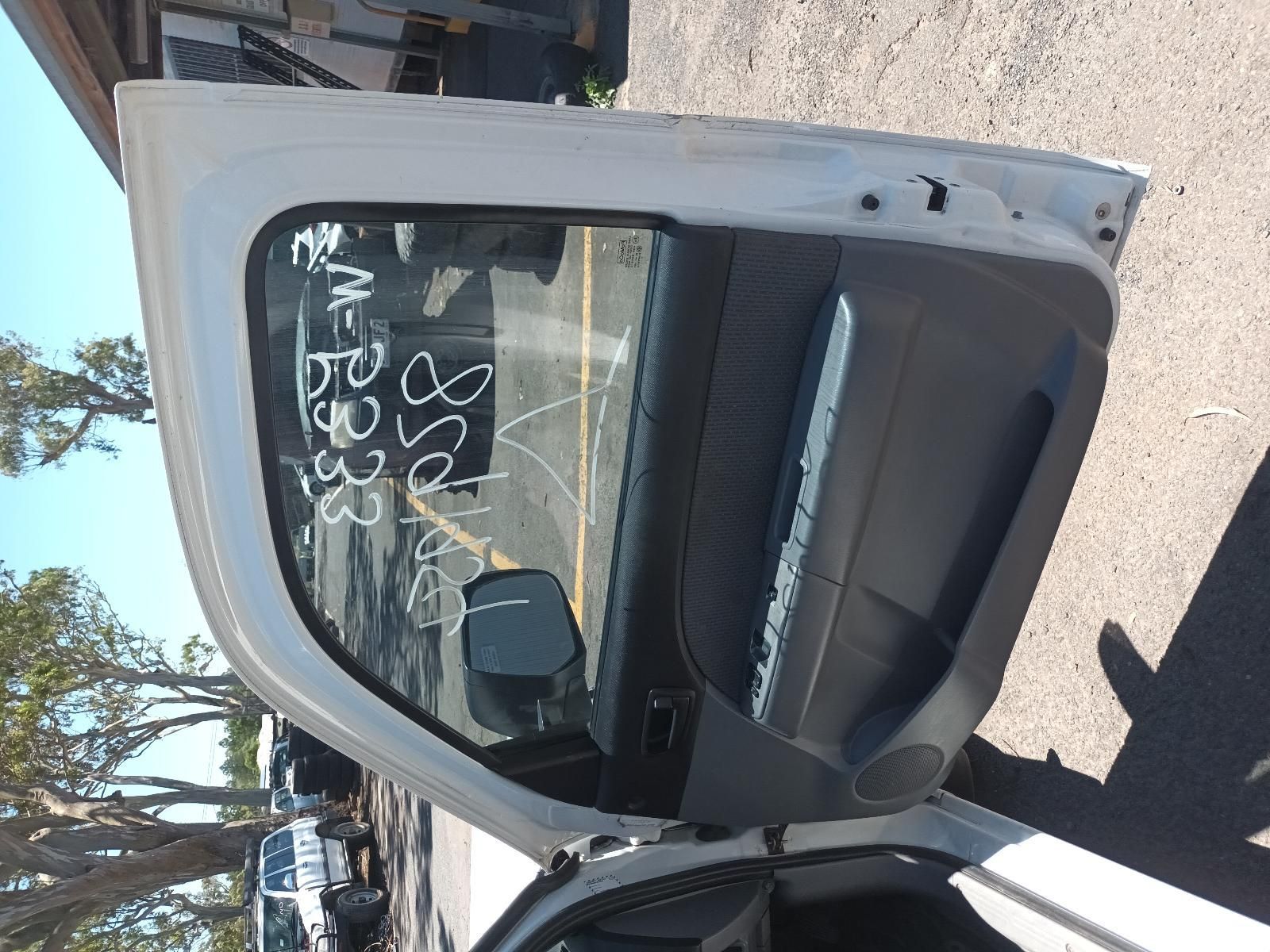 Damaged White Car Door with Shattered Window Parked on A Sunny Street — South West 4WD Wreckers In Harristown, QLD
