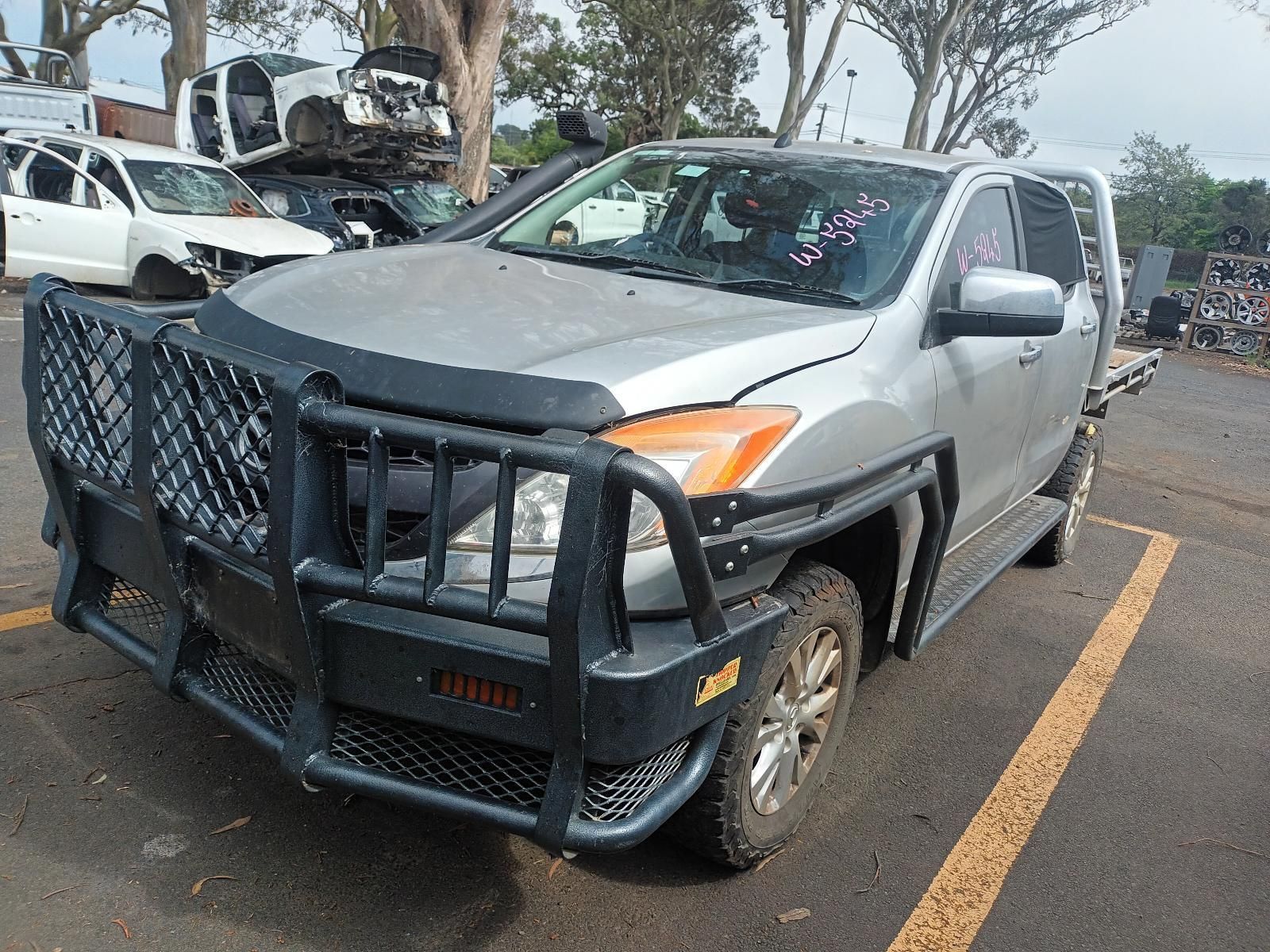 A Green Jeep With a Tent on Top of It is Parked in a Parking Lot — South West 4WD Wreckers In Brisbane, QLD