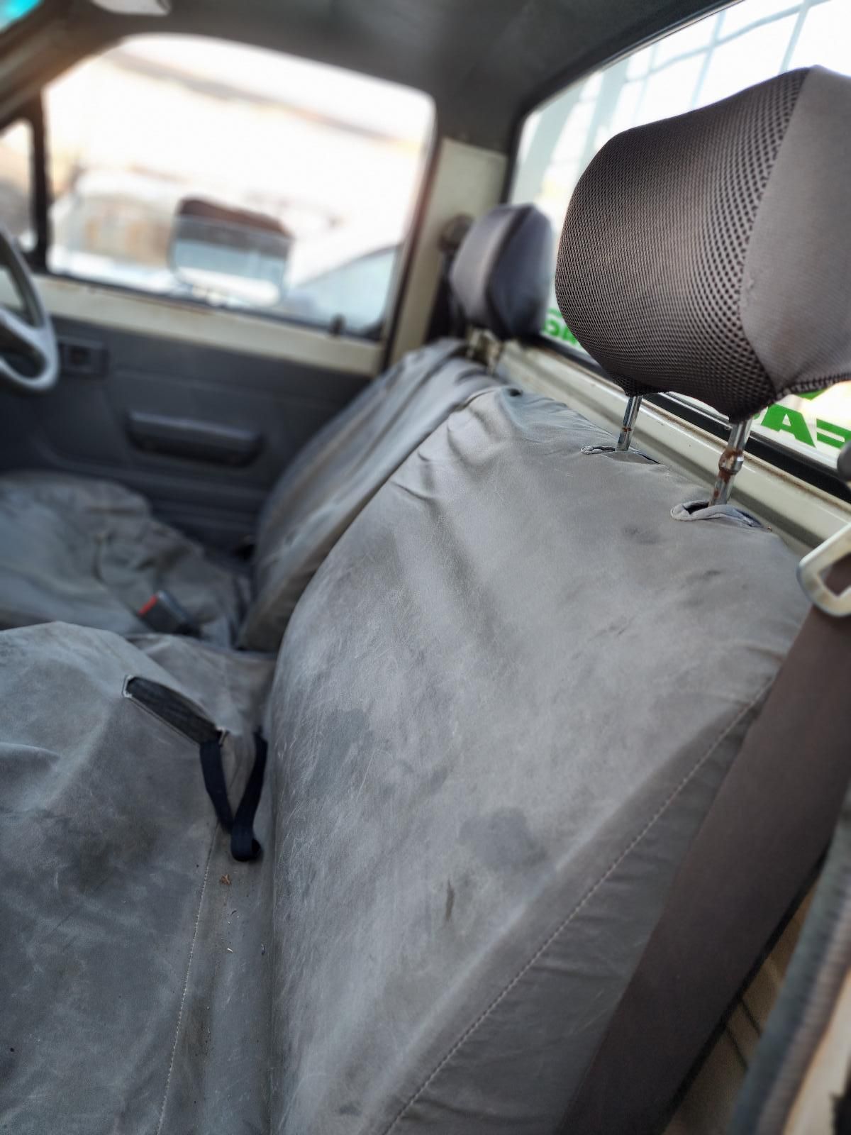 Gray Car Seat Cover on a Front Seat Inside a Vehicle — South West 4WD Wreckers In Harristown, QLD