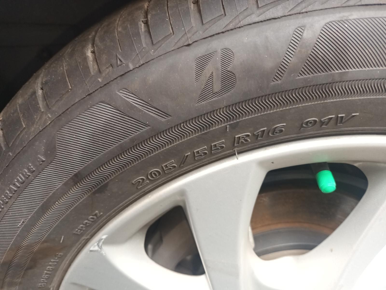 Close-Up of A Car Tire and Silver Wheel Rim with A Small Green Valve Cap Visible — South West 4WD Wreckers In Harristown, QLD