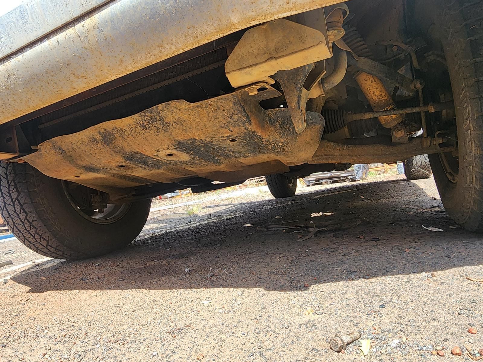 Undercarriage of a Dusty Car, Showing Rusted Exhaust — South West 4WD Wreckers In Harristown, QLD