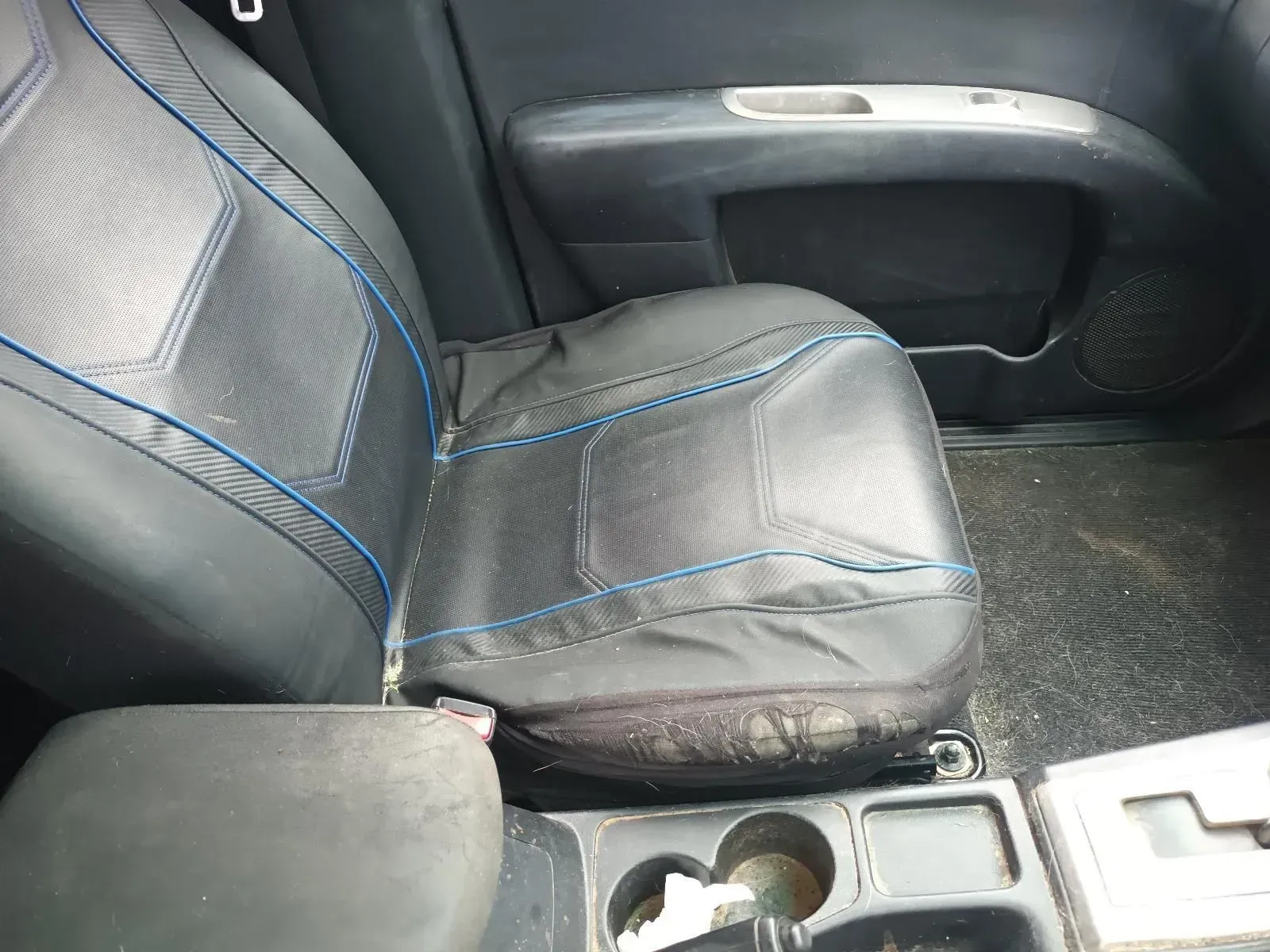 Black Car Seat With Blue Stitching; Center Console With Cup Holders — South West 4WD Wreckers In Harristown, QLD
